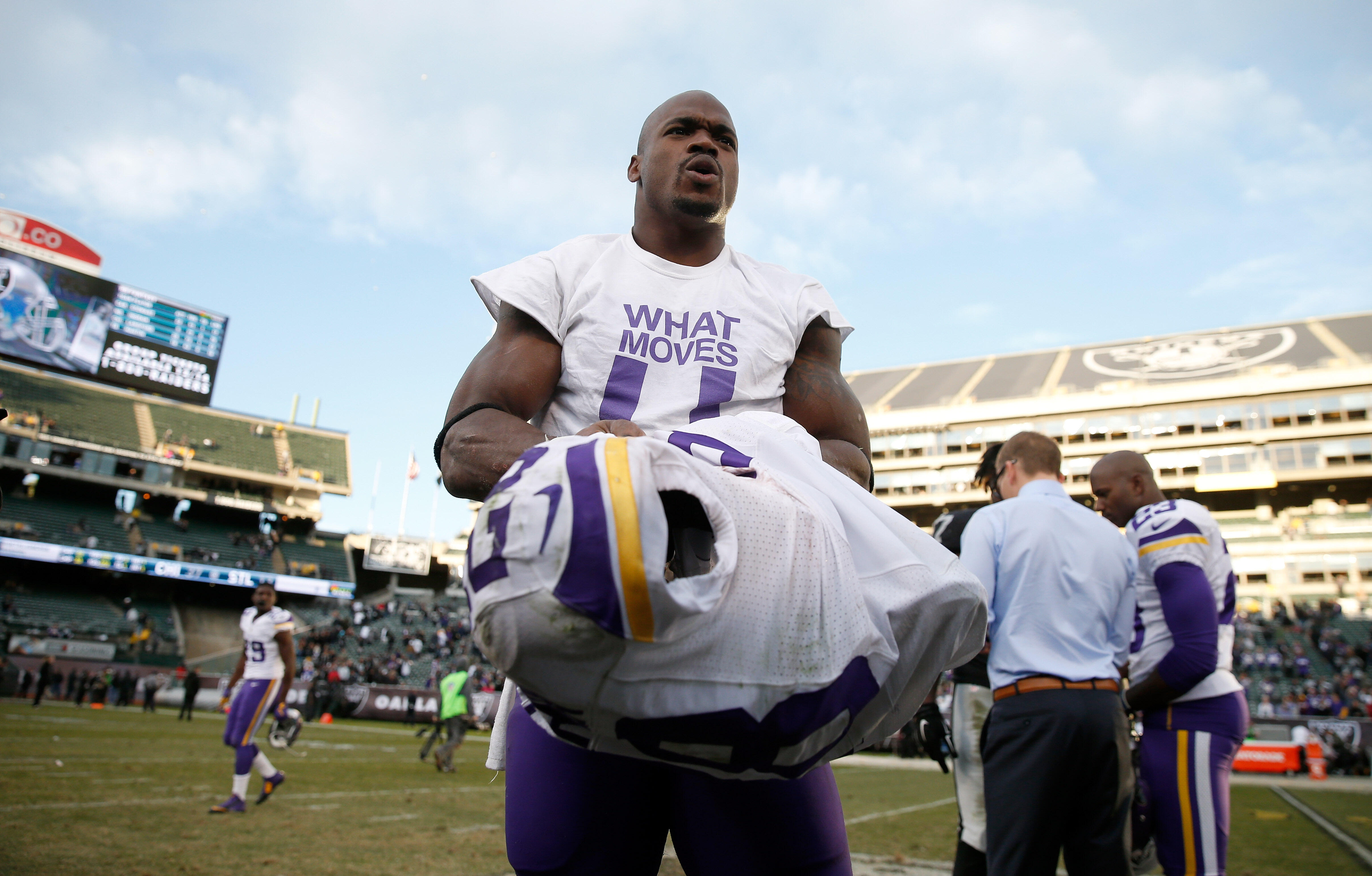 OAKLAND, CA - NOVEMBER 15:  Adrian Peterson #28 of the Minnesota Vikings takes off his jersey after his game against the Oakland Raiders at O.co Coliseum on November 15, 2015 in Oakland, California.  (Photo by Ezra Shaw/Getty Images)