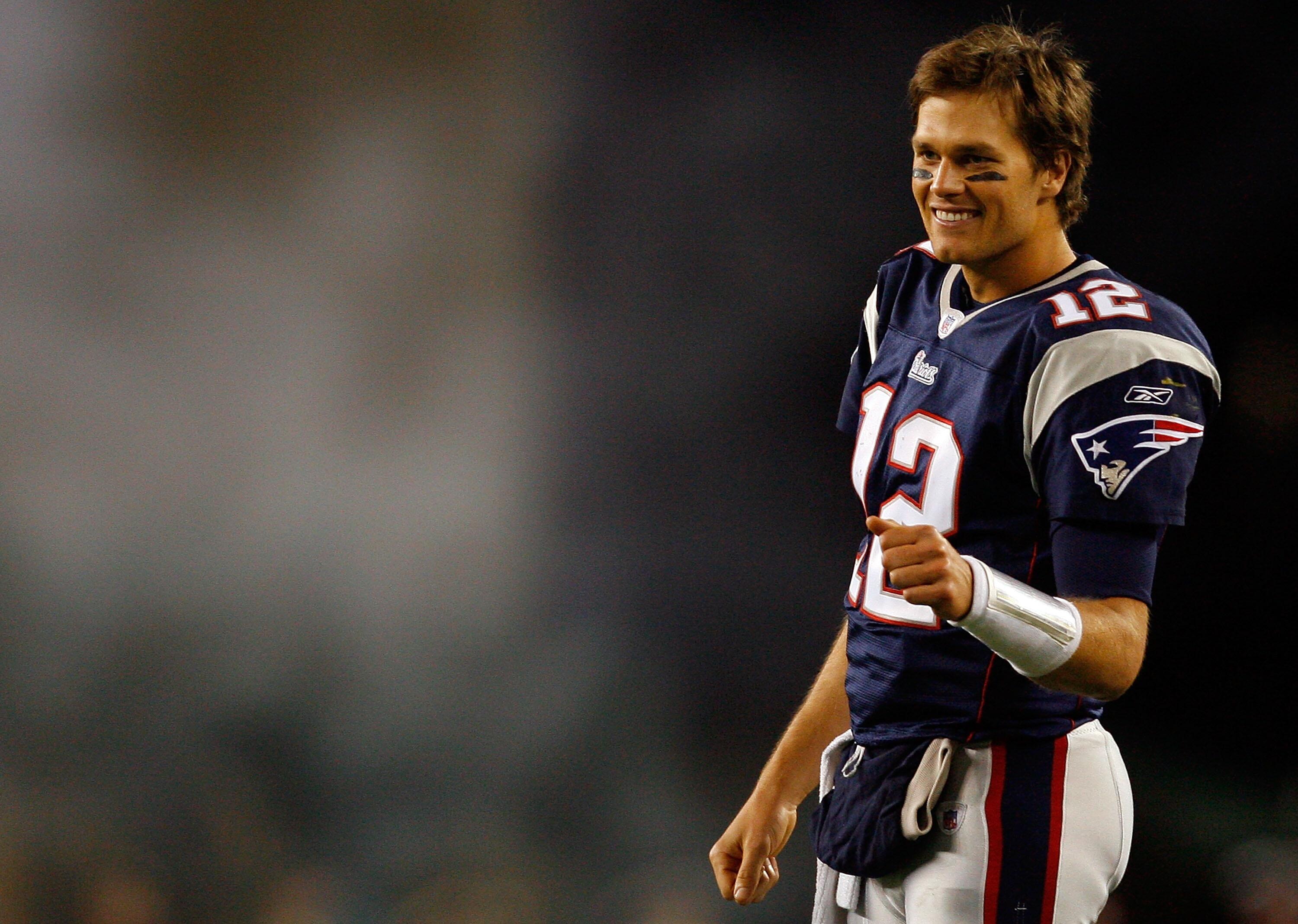 FOXBORO, MA - OCTOBER 28:  Tom Brady #12 of the New England Patriots waits to congratulate teammate Matt Cassel after he scored a touchdown in the fourth quarter against the Washington Redskins on October 28, 2007 at Gillette Stadium in Foxboro, Massachus