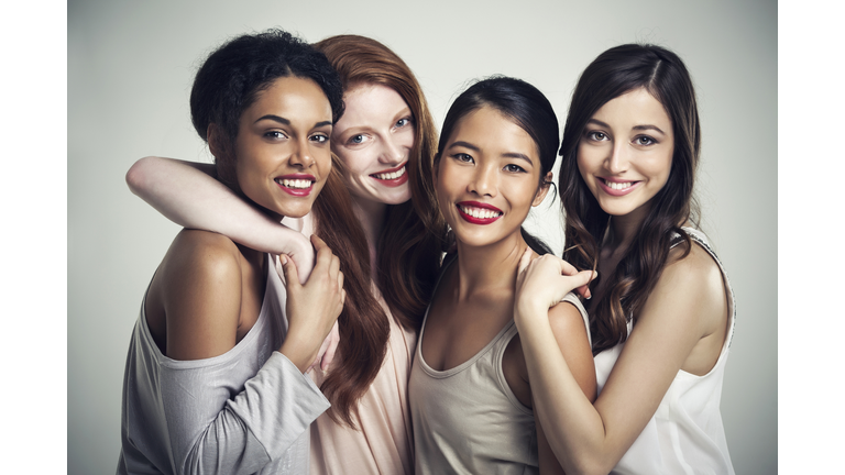 Close up of smiling women hugging
