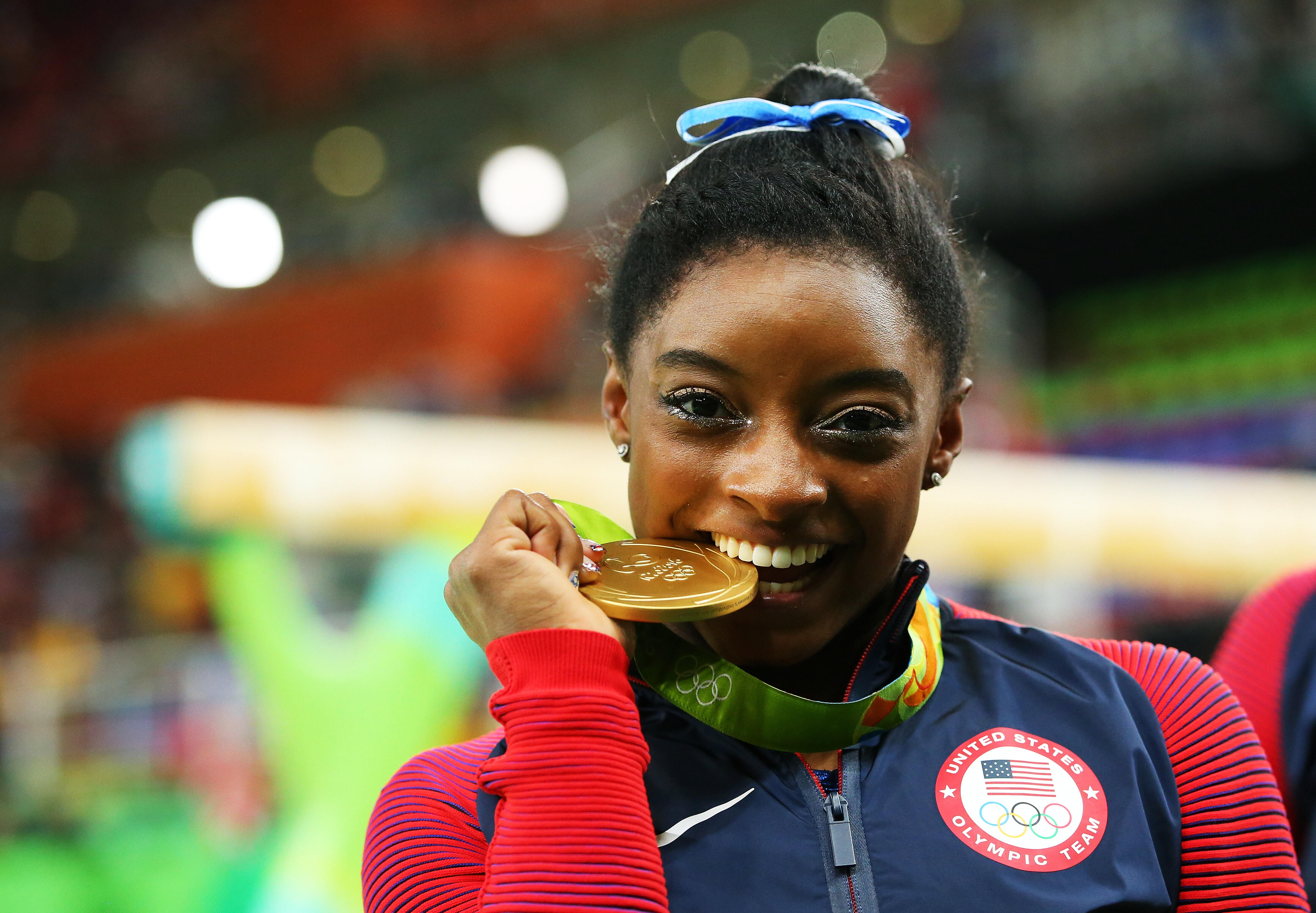 RIO DE JANEIRO, BRAZIL - AUGUST 11:  Gold medalist Simone Biles of the United States poses for photographs after the medal ceremony for the Women's Individual All Around on Day 6 of the 2016 Rio Olympics at Rio Olympic Arena on August 11, 2016 in Rio de J
