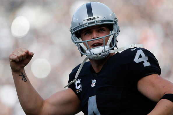 OAKLAND, CA - NOVEMBER 27:  Derek Carr #4 of the Oakland Raiders celebrates after a touchdown by Latavius Murray #28 against the Carolina Panthers during their NFL game on November 27, 2016 in Oakland, California.  (Photo by Lachlan Cunningham/Getty Images)
