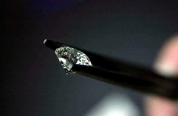 ANTWERP, BELGIUM - OCTOBER 31:  A diamond factory employee examines a diamond October 31, 2002 in Antwerp, Belgium. The gem traders in Antwerp are under pressure to regulate the sales of 