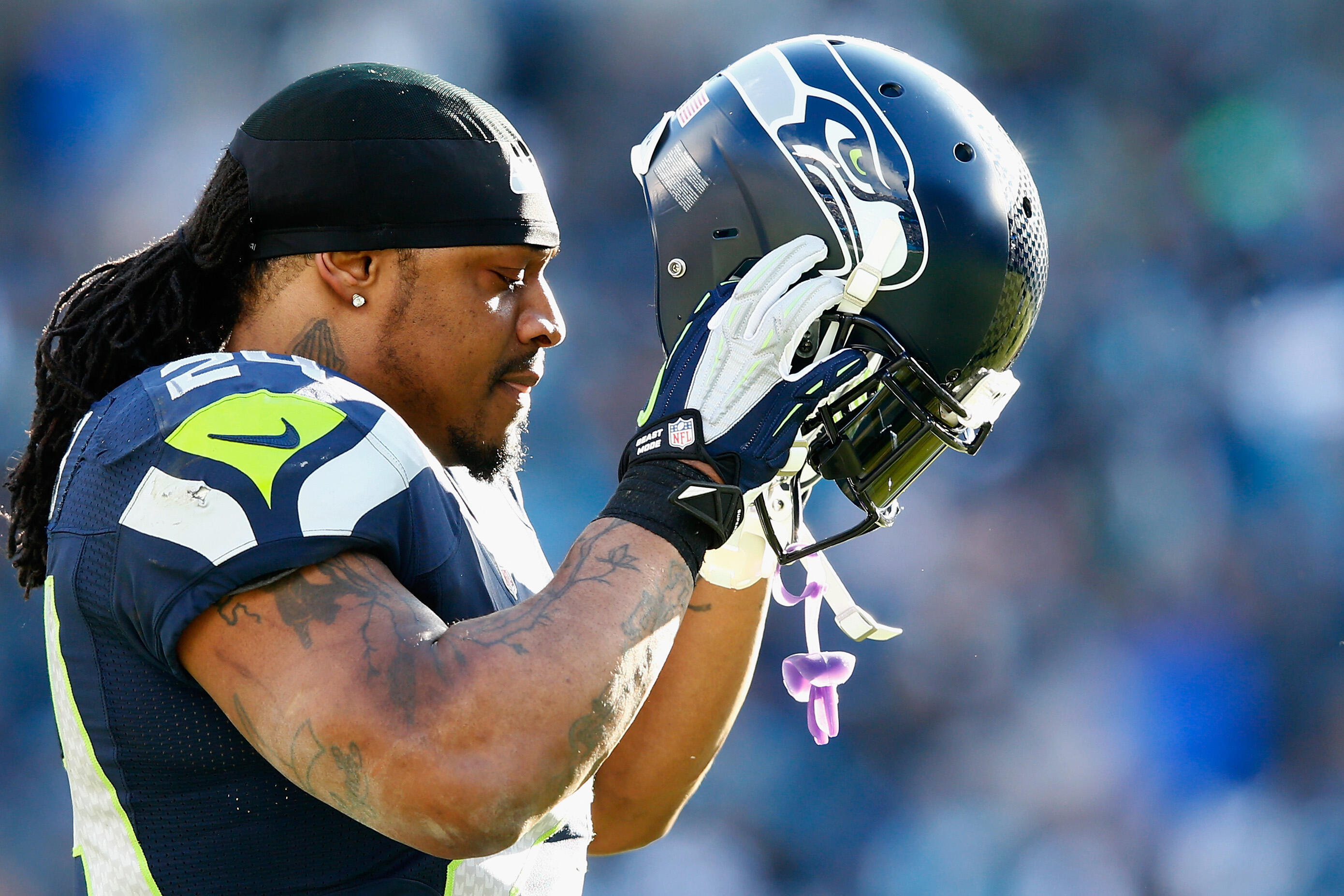 CHARLOTTE, NC - JANUARY 17:  Marshawn Lynch #24 of the Seattle Seahawks looks on during the third quarter of the NFC Divisional Playoff Game against the Carolina Panthers at Bank of America Stadium on January 17, 2016 in Charlotte, North Carolina.  (Photo