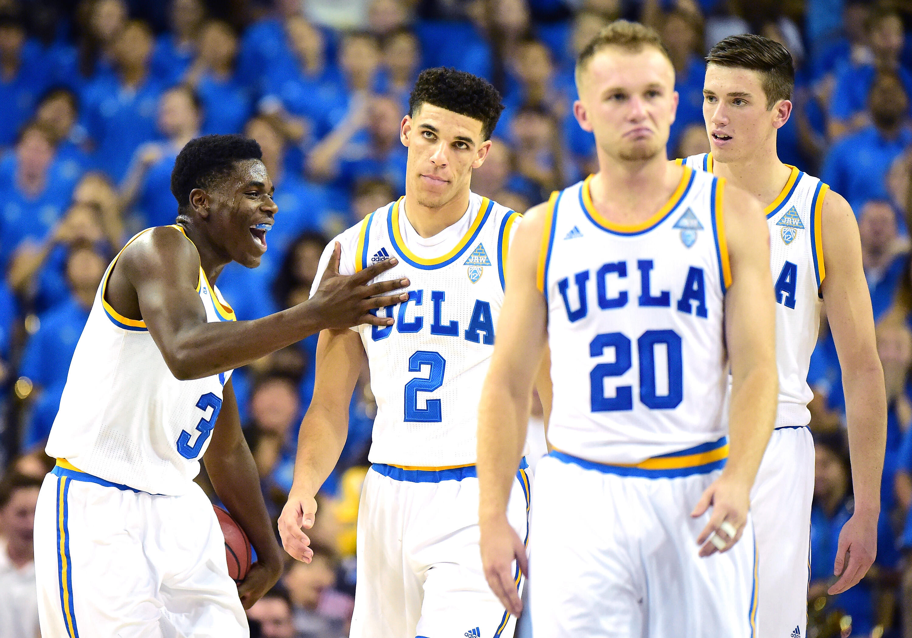 LOS ANGELES, CA - NOVEMBER 11:  Aaron Holiday #3 of the UCLA Bruins reacts to a dunk from Lonzo Ball #2 as TJ Leaf #22 and Bryce Alford #20 walk back during the first half against the Pacific Tigers at Pauley Pavilion on November 11, 2016 in Los Angeles, 