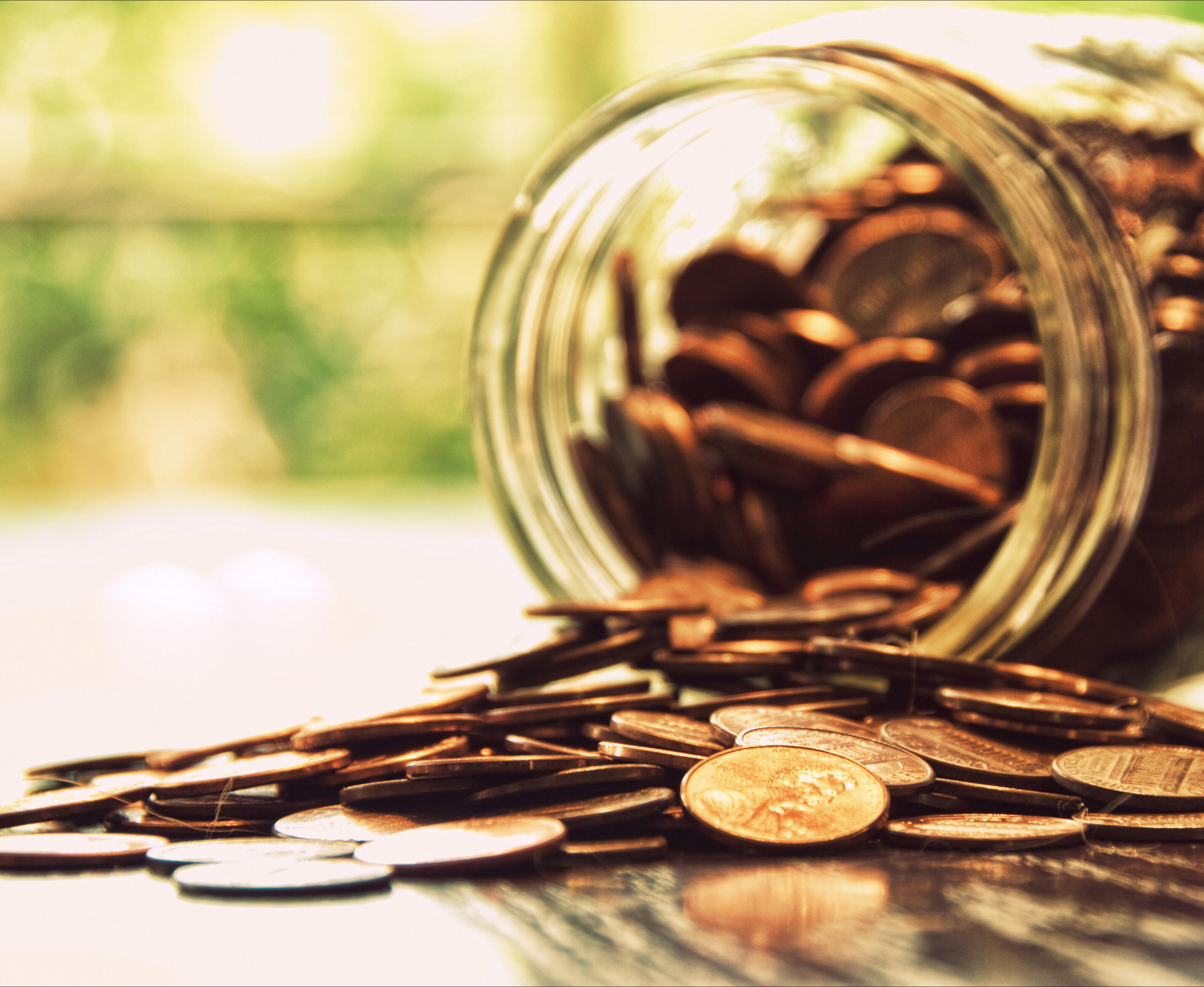 Coins spilled from jar, close up