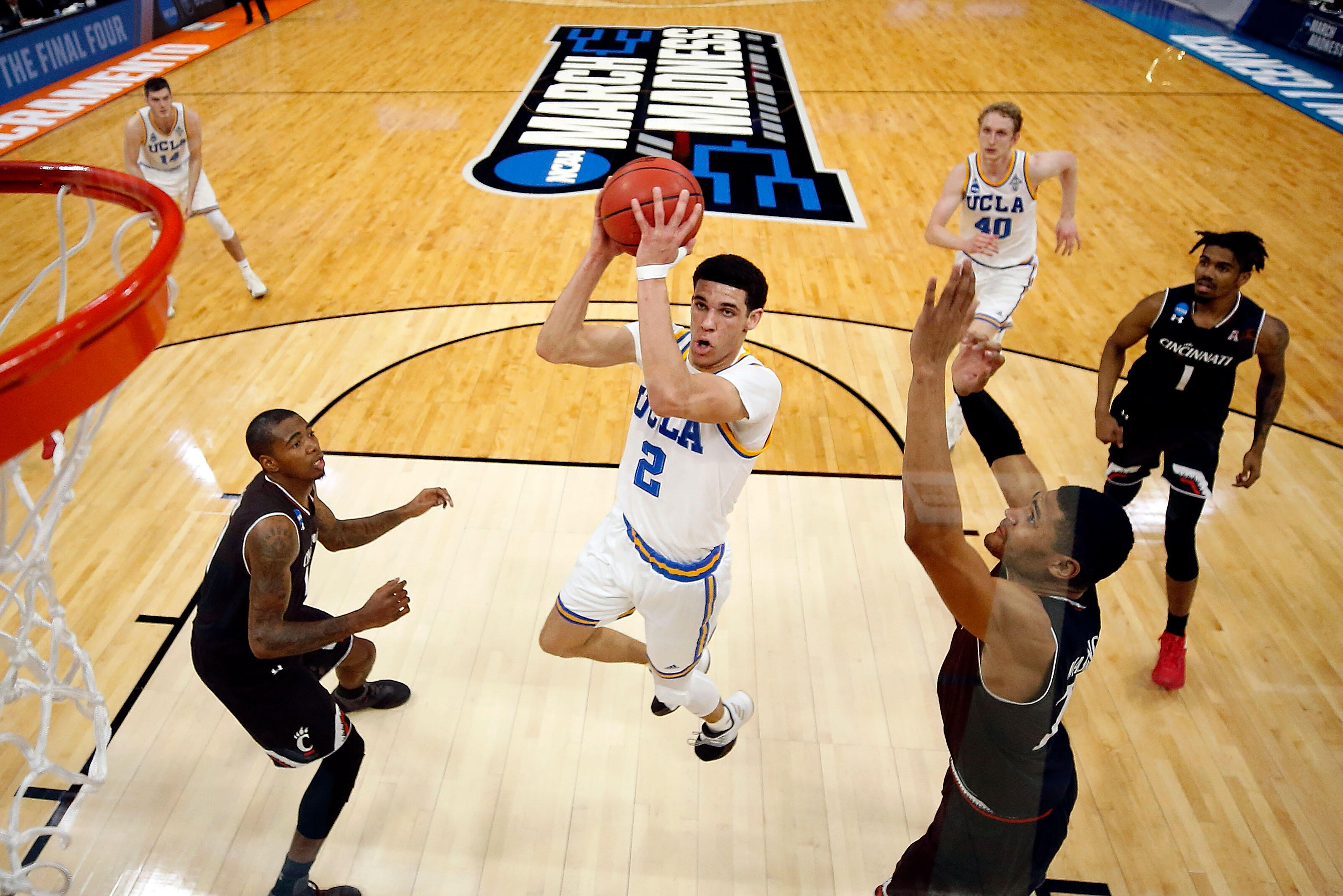 SACRAMENTO, CA - MARCH 19:  Lonzo Ball #2 of the UCLA Bruins drives to the basket as Kyle Washington #24 of the Cincinnati Bearcats defends during the second round of the NCAA Basketball Tournament at Golden 1 Center on March 19, 2017 in Sacramento, Calif