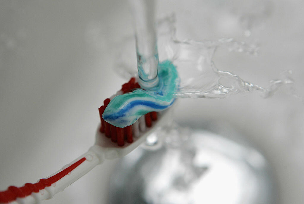 SCHWELM, GERMANY - JANUARY 10:  Water pours onto a toothbrush with toothpaste on January 10, 2007 in Schwelm, Germany.  (Photo Illustration by Christof Koepsel/Getty Images)