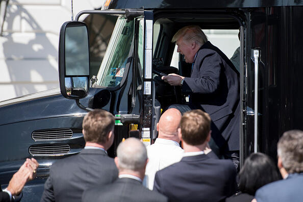 US President Donald Trump sits in the drivers seat of a semi-truck as he welcomes truckers and CEOs to the White House in Washington, DC, March 23, 2017, to discuss healthcare. / AFP PHOTO / JIM WATSON        (Photo credit should read JIM WATSON/AFP/Getty Images)