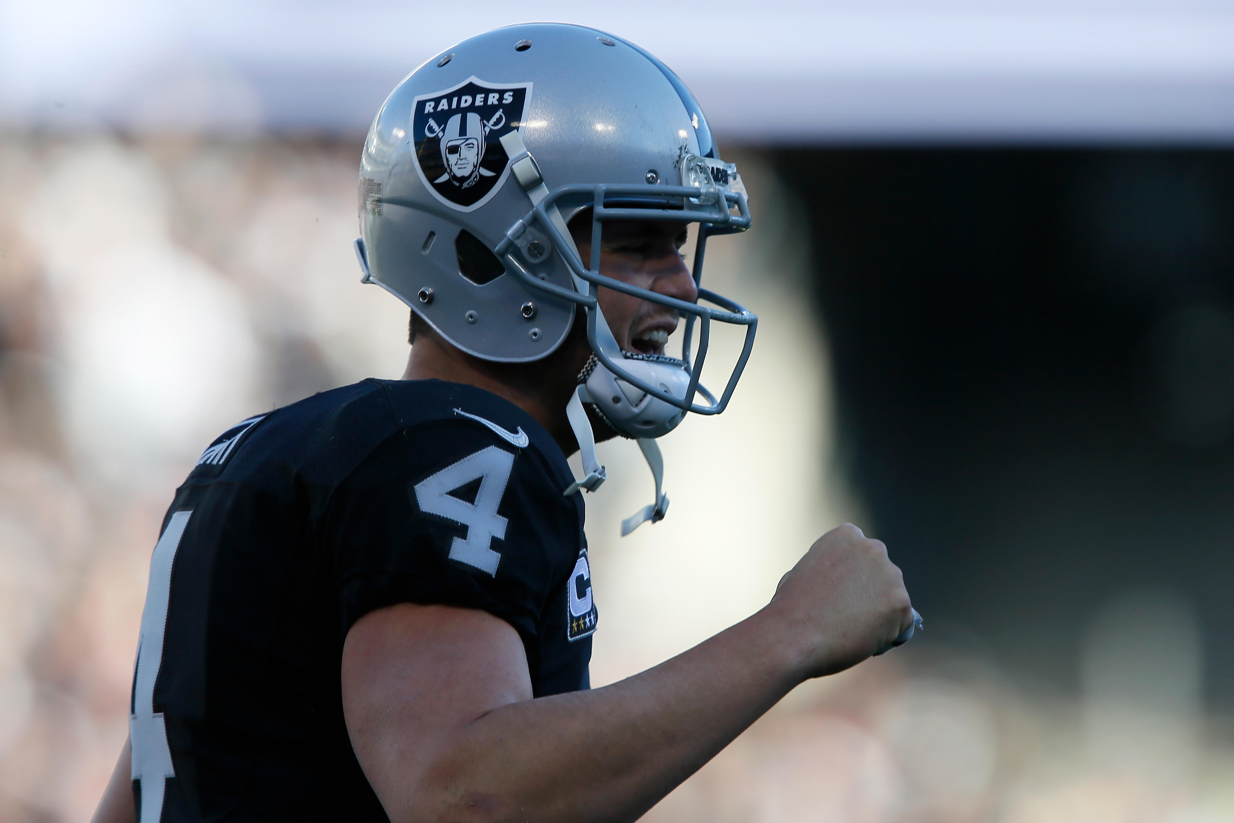 OAKLAND, CA - DECEMBER 24:  Derek Carr #4 of the Oakland Raiders celebrates after a DeAndre Washington #33 22-yard touchdown against the Indianapolis Colts during their NFL game at Oakland Alameda Coliseum on December 24, 2016 in Oakland, California.  (Ph