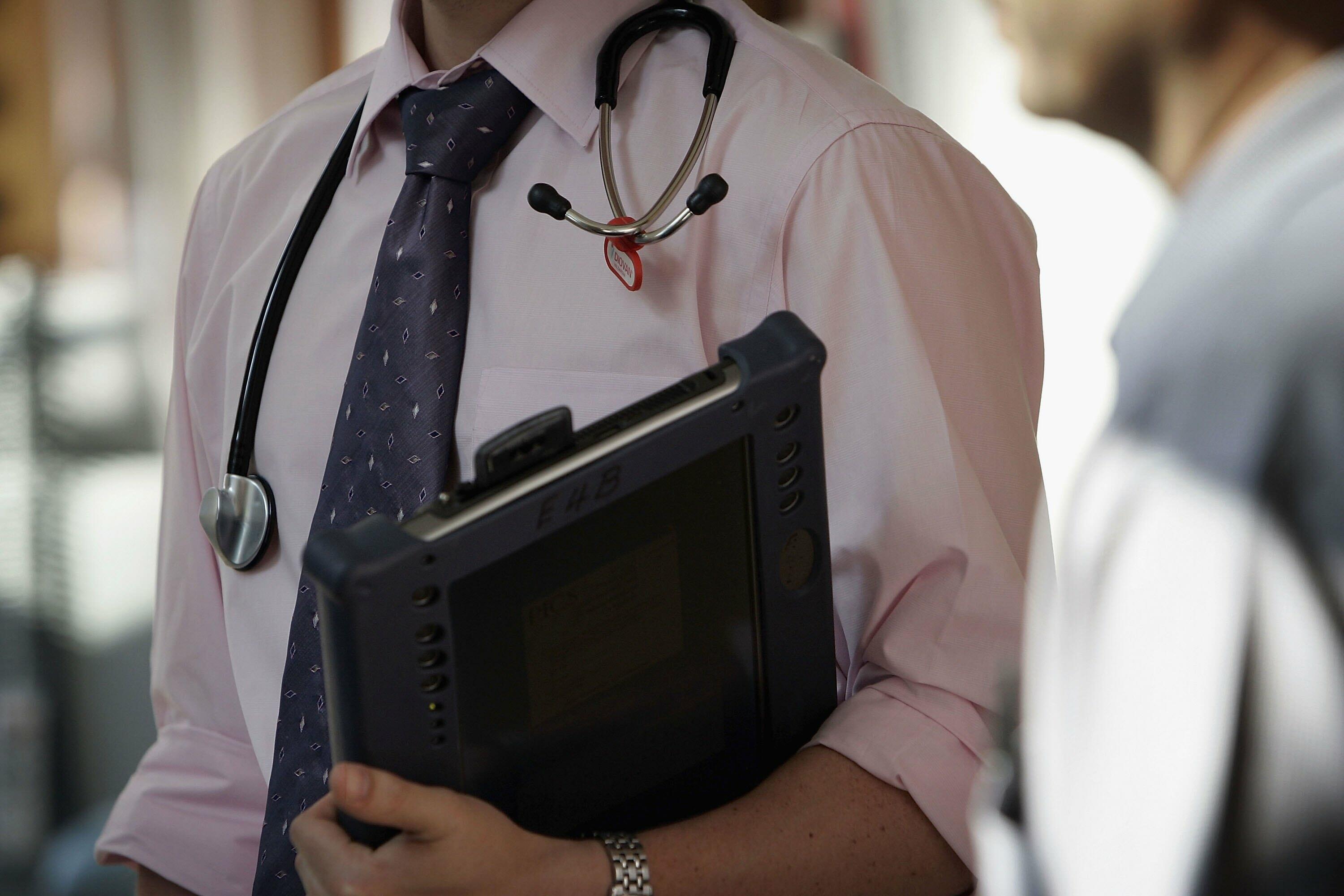 BIRMINGHAM, UNITED KINGDOM - JUNE 14:  A doctor at The Queen Elizabeth Hospital Birmingham does his rounds on the wards on June 14, 2006 in Birmingham, England. Senior managers of the NHS have said that the organisation needs to become more open in the fu