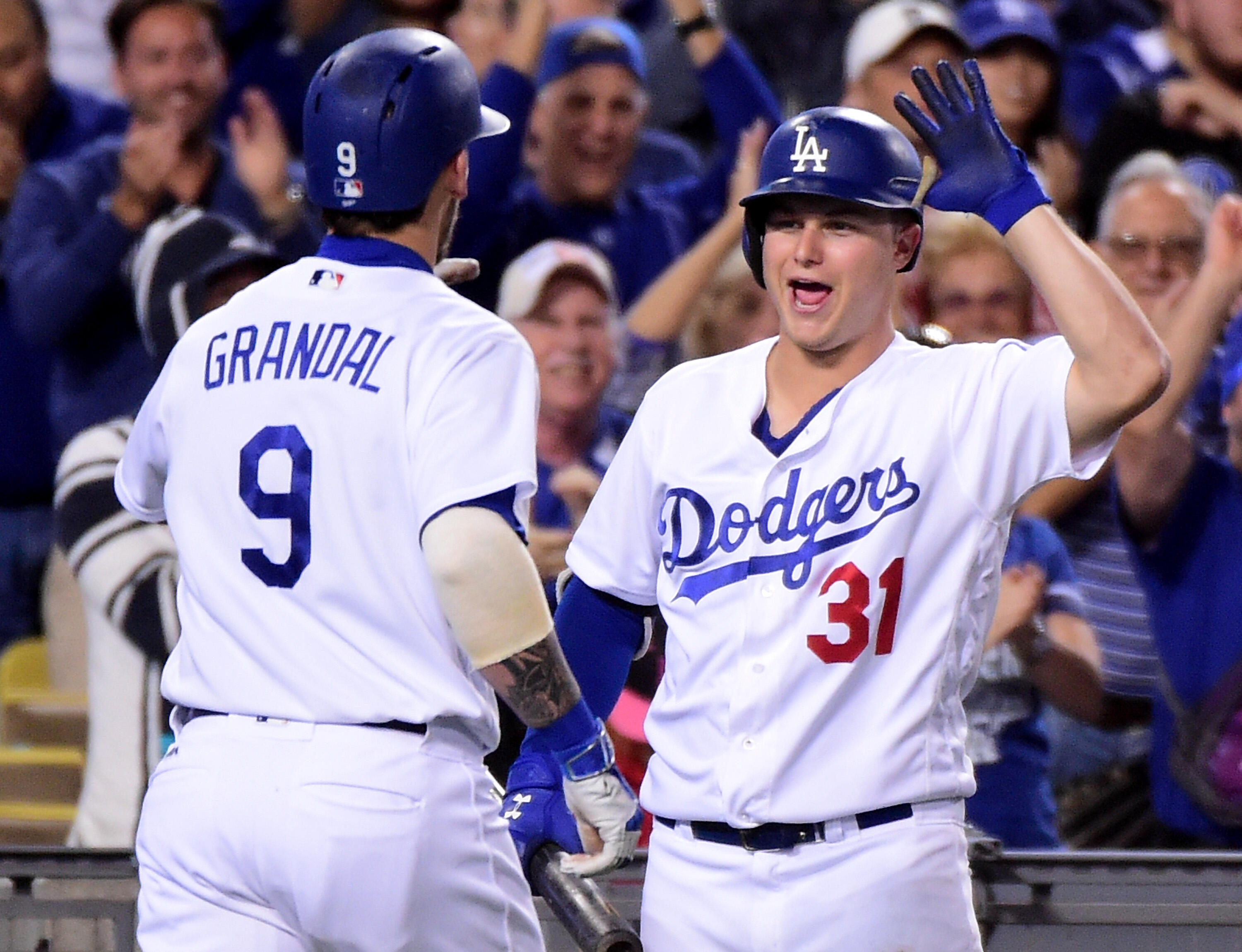 LOS ANGELES, CA - SEPTEMBER 22:  Joc Pederson #31 of the Los Angeles Dodgers reacts to a grand slam homerun from Yasmani Grandal #9 of the Los Angeles Dodgers to take a 7-4 lead over the Colorado Rockies during the seventh inning at Dodger Stadium on Sept