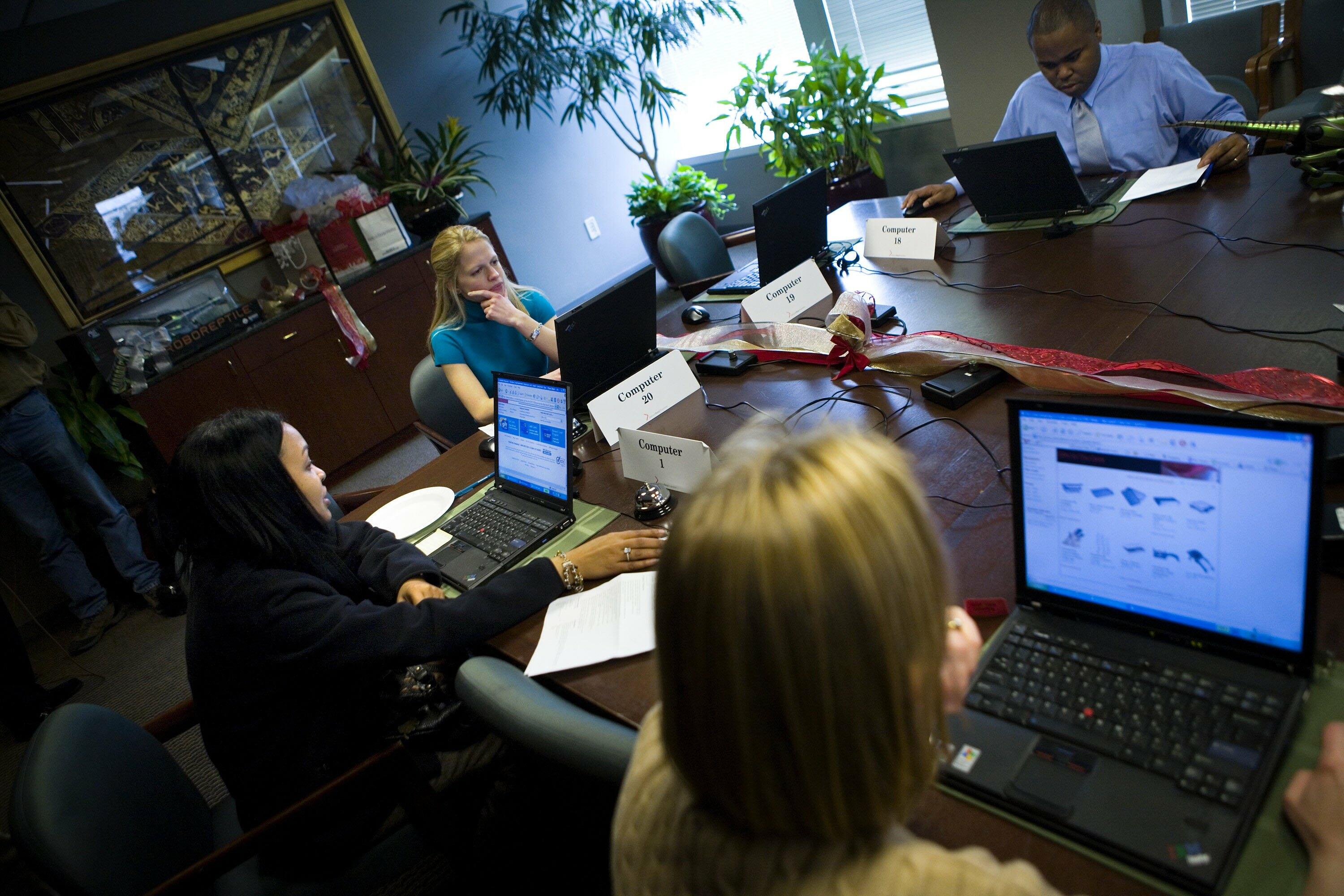 WASHINGTON - NOVEMBER 27:  Consumers shop online during a shop and lunch event in the boardroom of the National Retail Federation November 27, 2006 in Washington, DC. The National Retail Federation, a retail trade group, provided laptop computers, persona