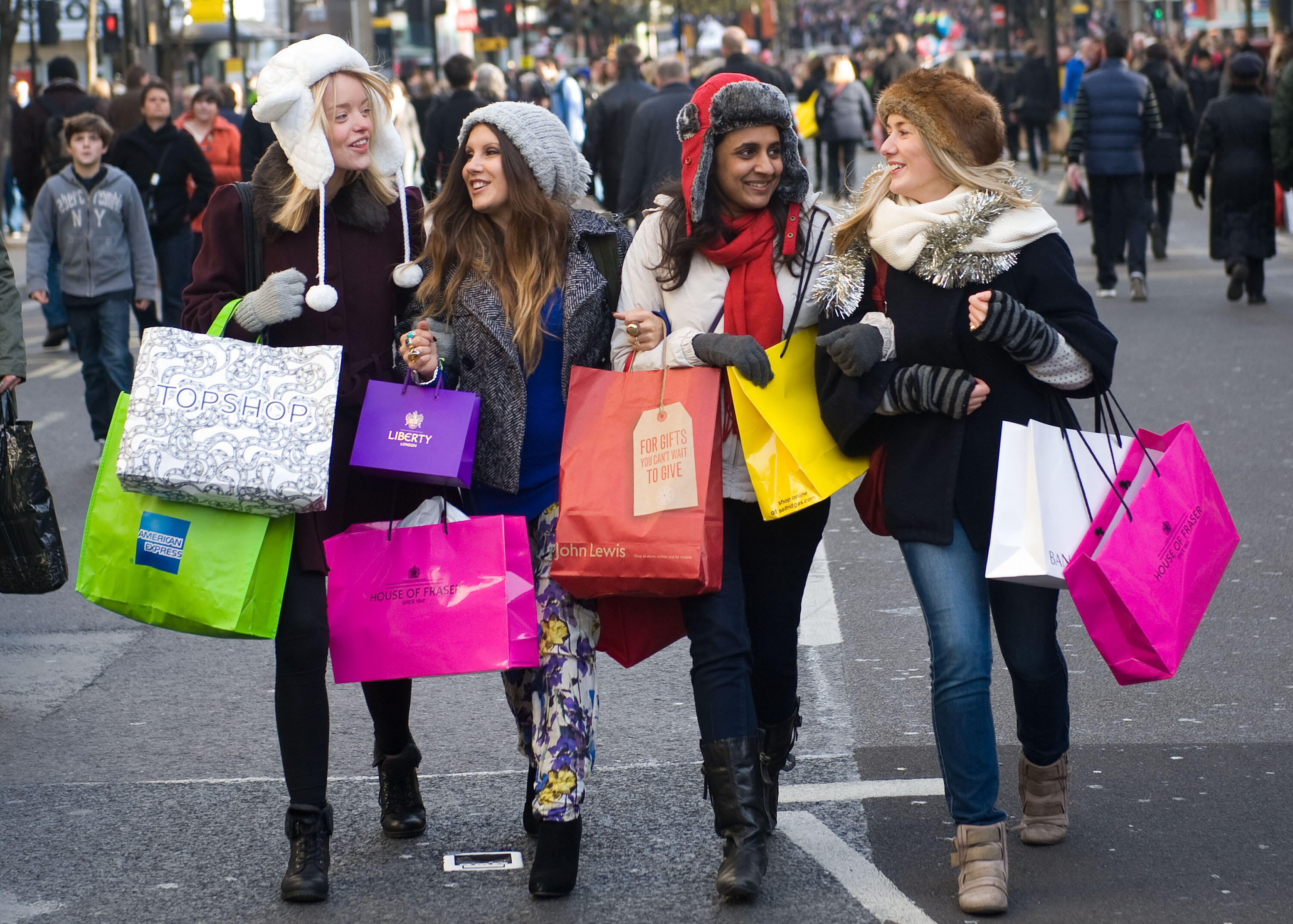 LONDON - DECEMBER 10:  Shoppers walk down Oxford Street during American Express Shop West End VIP Weekend on DECEMBER 10, 2011 in London, England. West End stores predict ?180m sales today with 1m shoppers spending on fashions and gifts. Over 50,000 'earl