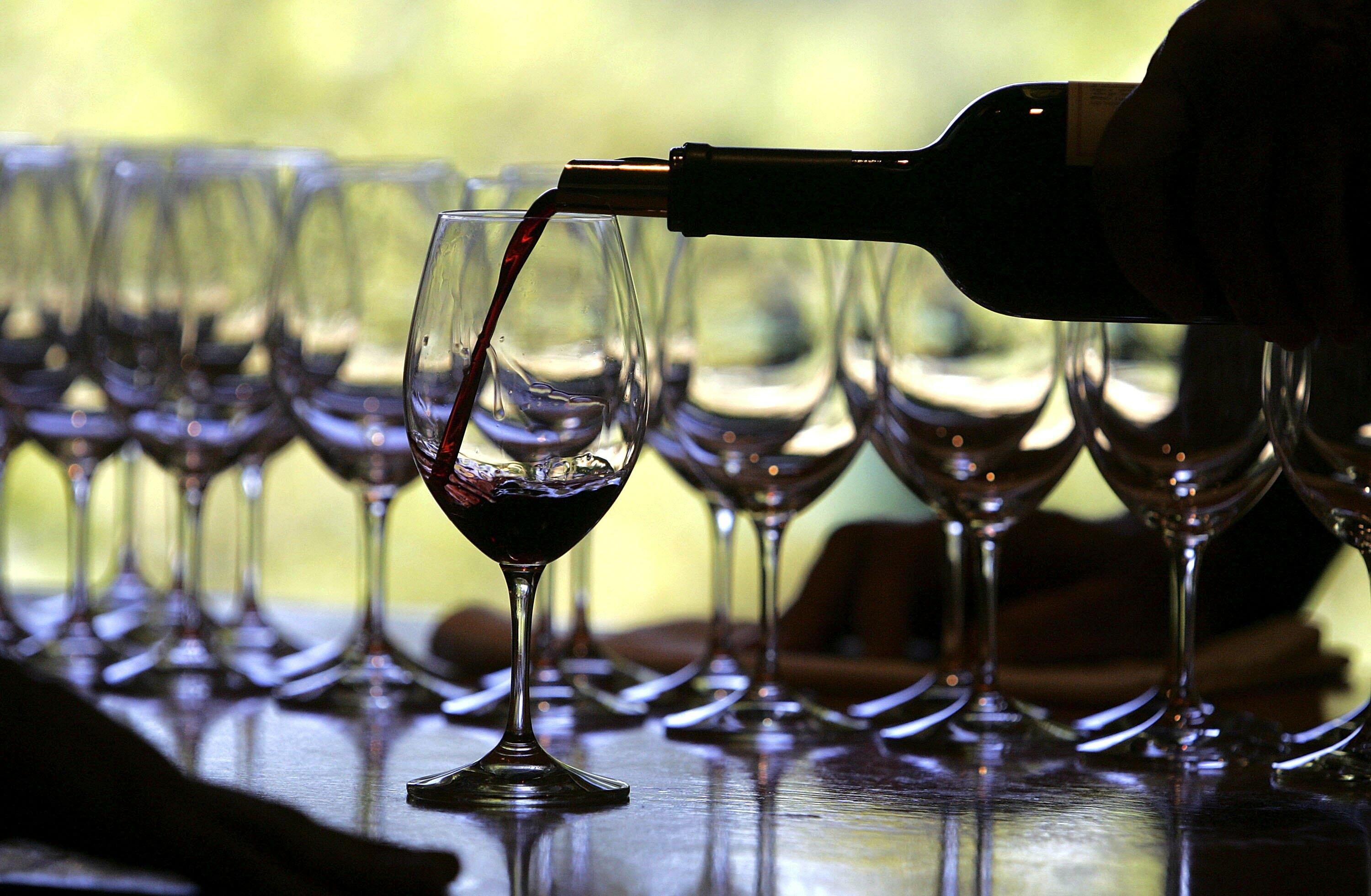 RUTHERFORD, CA - SEPTEMBER 20:  A worker at St. Supery winery pours a glass of wine for a tasting September 20, 2006 in Rutherford, California. Wineries in the Napa Valley region are in the midst of harvesting their 2006 crop and will pick and crush grape