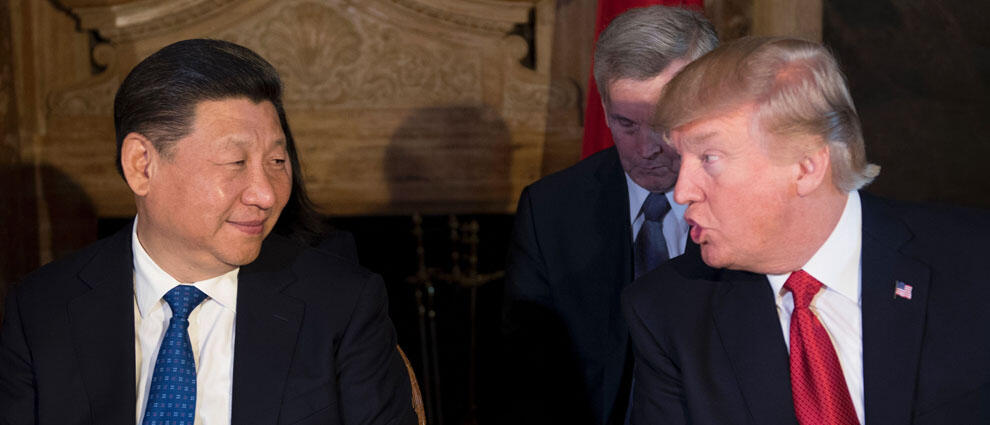 US President Donald Trump (R) and Chinese President Xi Jinping (L) speak during dinner at the Mar-a-Lago estate in West Palm Beach, Florida, on April 6, 2017. / AFP PHOTO / JIM WATSON        (Photo credit should read JIM WATSON/AFP/Getty Images)