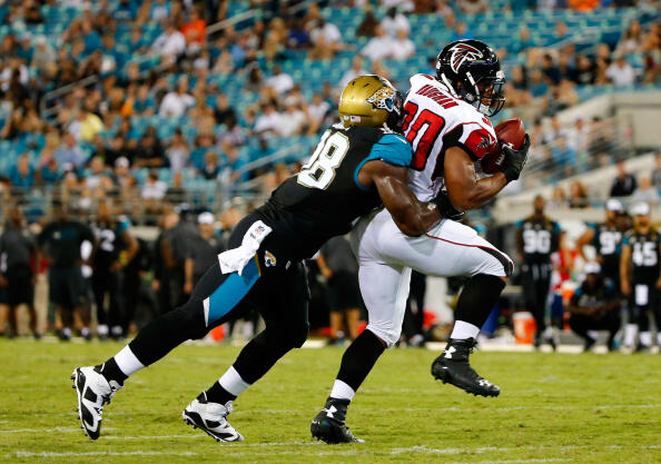 JACKSONVILLE, FL - AUGUST 28:  Josh Vaugh #30 of the Atlanta Falcons runs against  Chris Smith #98 of the Jacksonville Jaguars during the preseason NFL game at EverBank Field on August 28, 2014 in Jacksonville, Florida.  (Photo by Sam Greenwood/Getty Imag