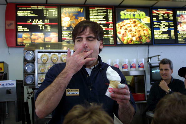 16 Jan 2002:  Dallas Mavericks owner Mark Cuban licks his fingers as he serves an ice cream cone while working at Dairy Queen in Coppell, Texas. Cuban accepted the offer to work at Dairy Queen after making a remark to NBA Director of Officiating, Ed Rush,