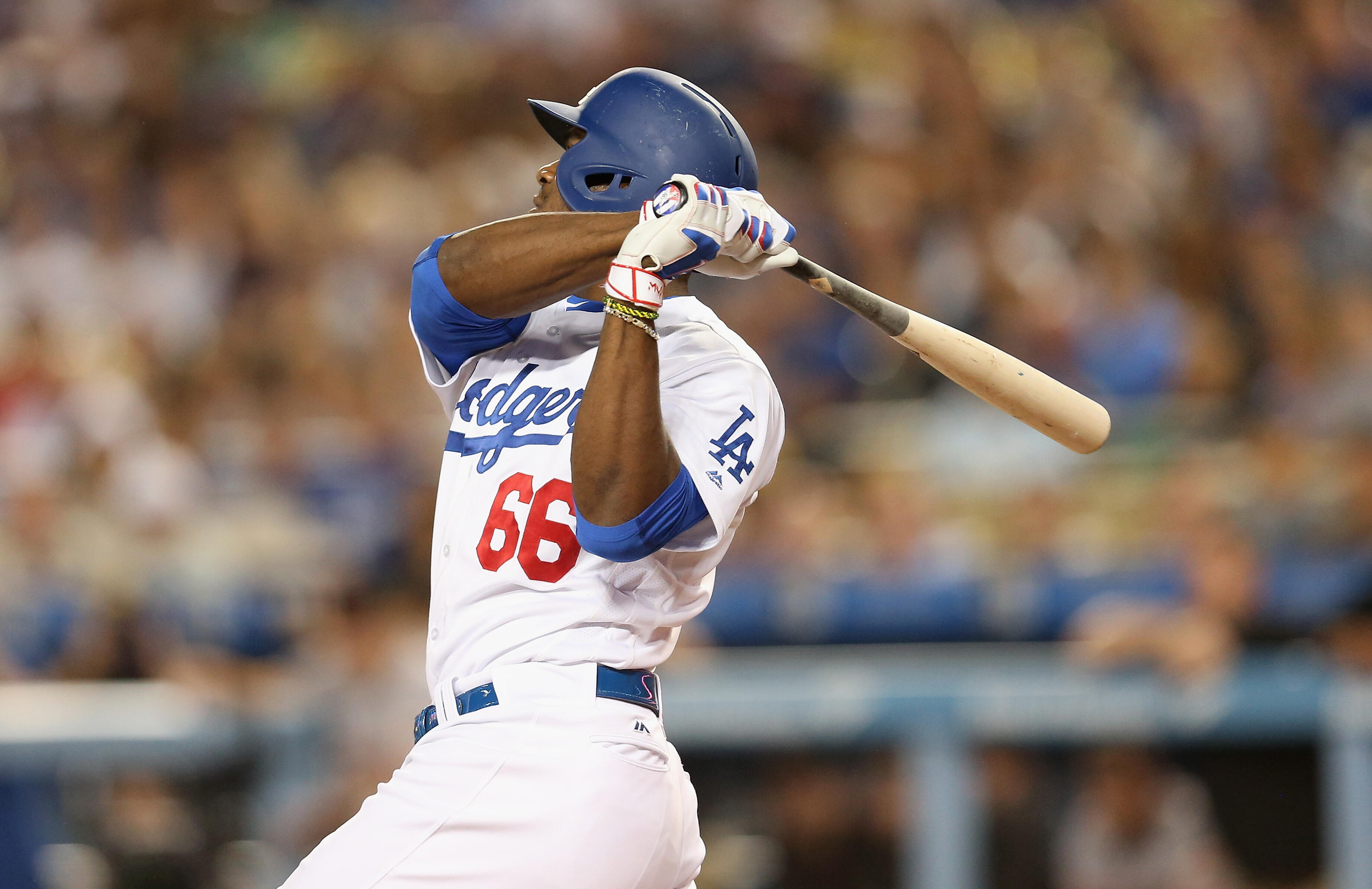 LOS ANGELES, CALIFORNIA - SEPTEMBER 21:  Yasiel Puig #66 of the Los Angeles Dodgers hits a three-run home run in the first inning against the San Francisco Giants at Dodger Stadium on September 21, 2016 in Los Angeles, California.  (Photo by Stephen Dunn/