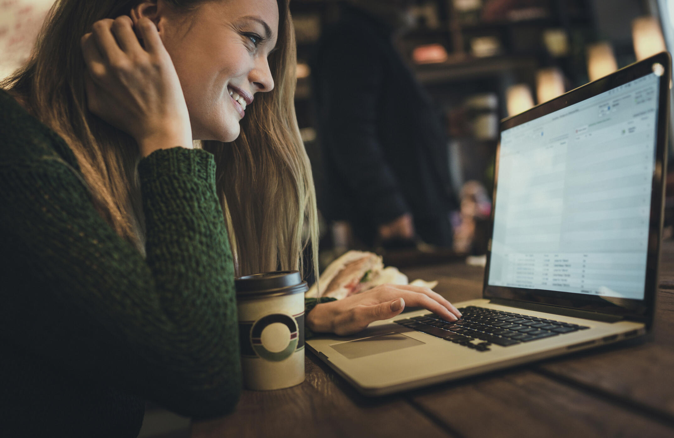 Young woman using laptop in cafe