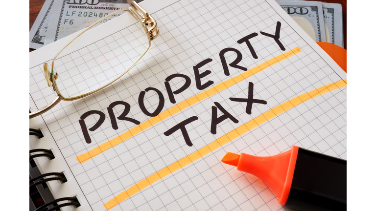 Notebook with property tax sign on a table.