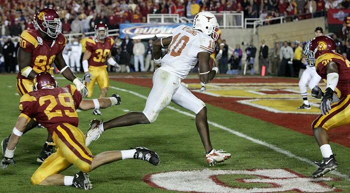 PASADENA, CA - JANUARY 04:  Vince Young #10 of the Texas Longhorns rushes past Frostee Rucker #90, Scott Ware #29 and Josh Pinkard #36 of the USC Trojans to score a 2 point conversion following his touchdown in the final moments of the BCS National Champi
