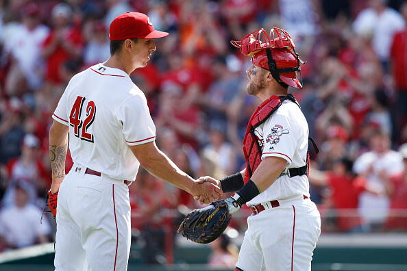 CINCINNATI, OH - APRIL 15: Michael Lorenzen #21 and Tucker Barnhart #16 of the Cincinnati Reds celebrate after the final out in the ninth inning of the game against the Milwaukee Brewers at Great American Ball Park on April 15, 2017 in Cincinnati, Ohio. The Reds defeated the Brewers 7-5. All players are wearing #42 in honor of Jackie Robinson Day. (Photo by Joe Robbins/Getty Images)