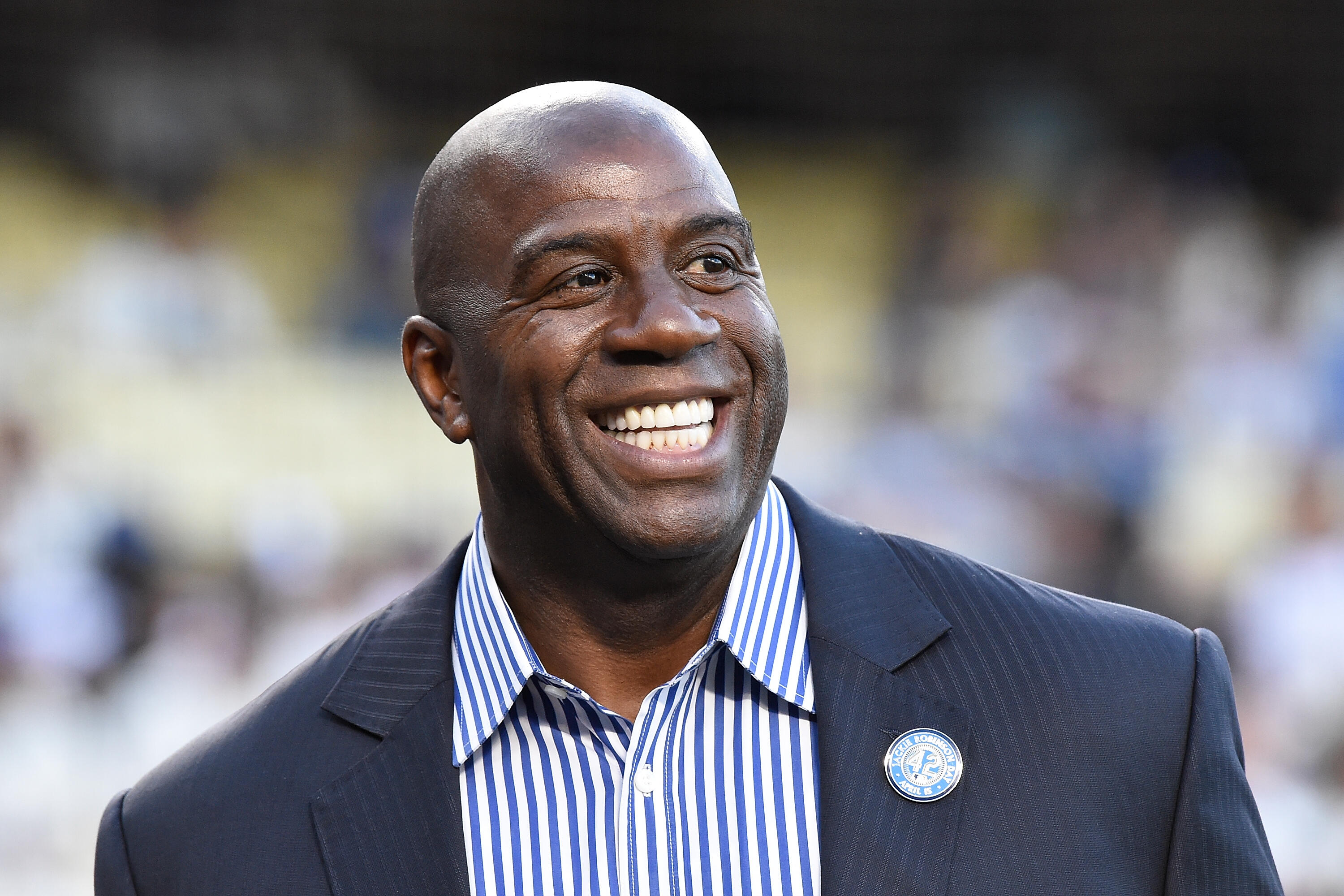 LOS ANGELES, CA - APRIL 15:  Magic Johnson attends a ceremony honoring Jackie Robinson before the game between the San Francisco Giants and the Los Angeles Dodgers at Dodger Stadium on April 15, 2016 in Los Angeles, California.  All players are wearing #4