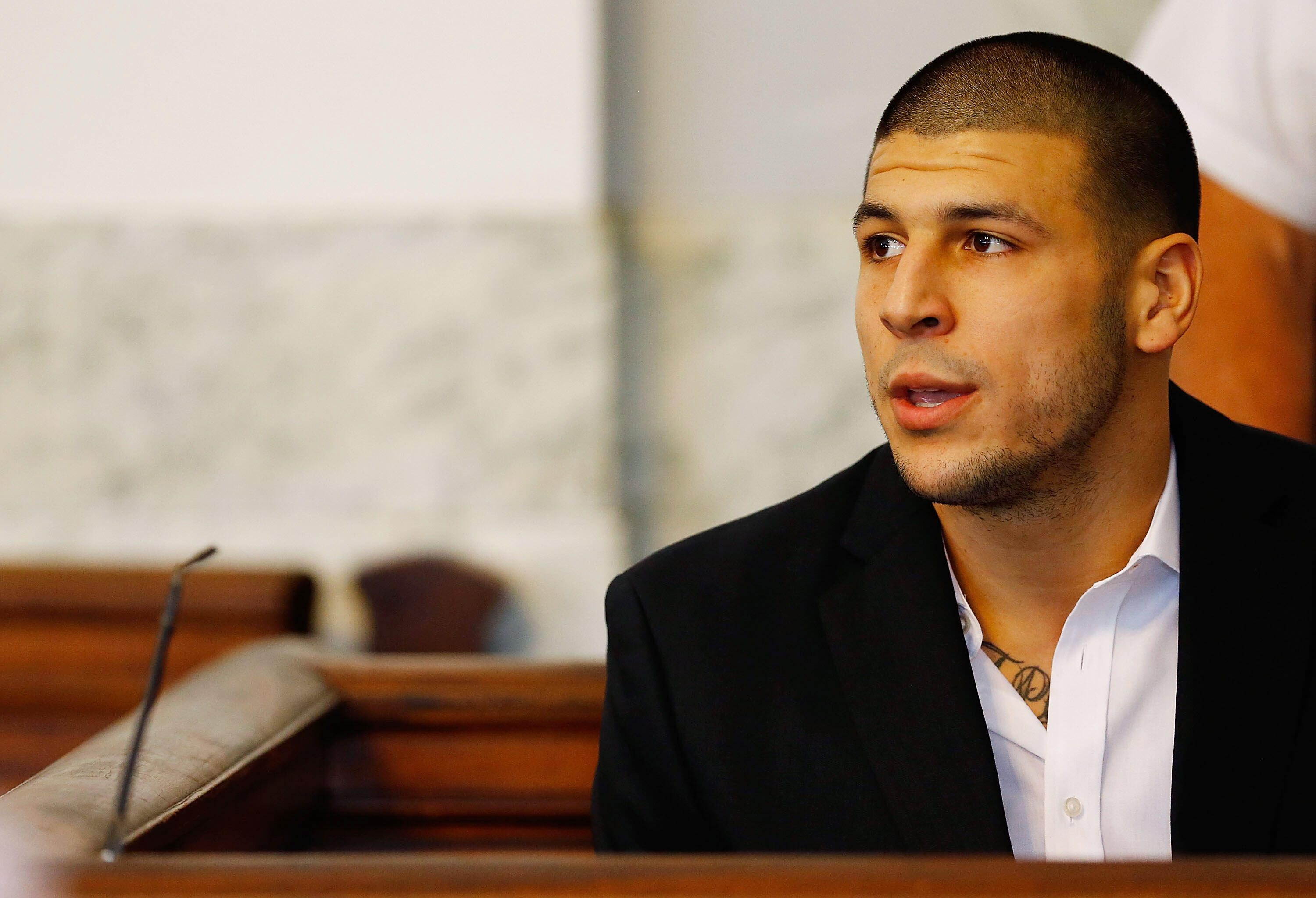 NORTH ATTLEBORO, MA - AUGUST 22: Aaron Hernandez sits in the courtroom of the Attleboro District Court during his hearing on August 22, 2013 in North Attleboro, Massachusetts. Former New England Patriot Aaron Hernandez has been indicted on a first-degree 