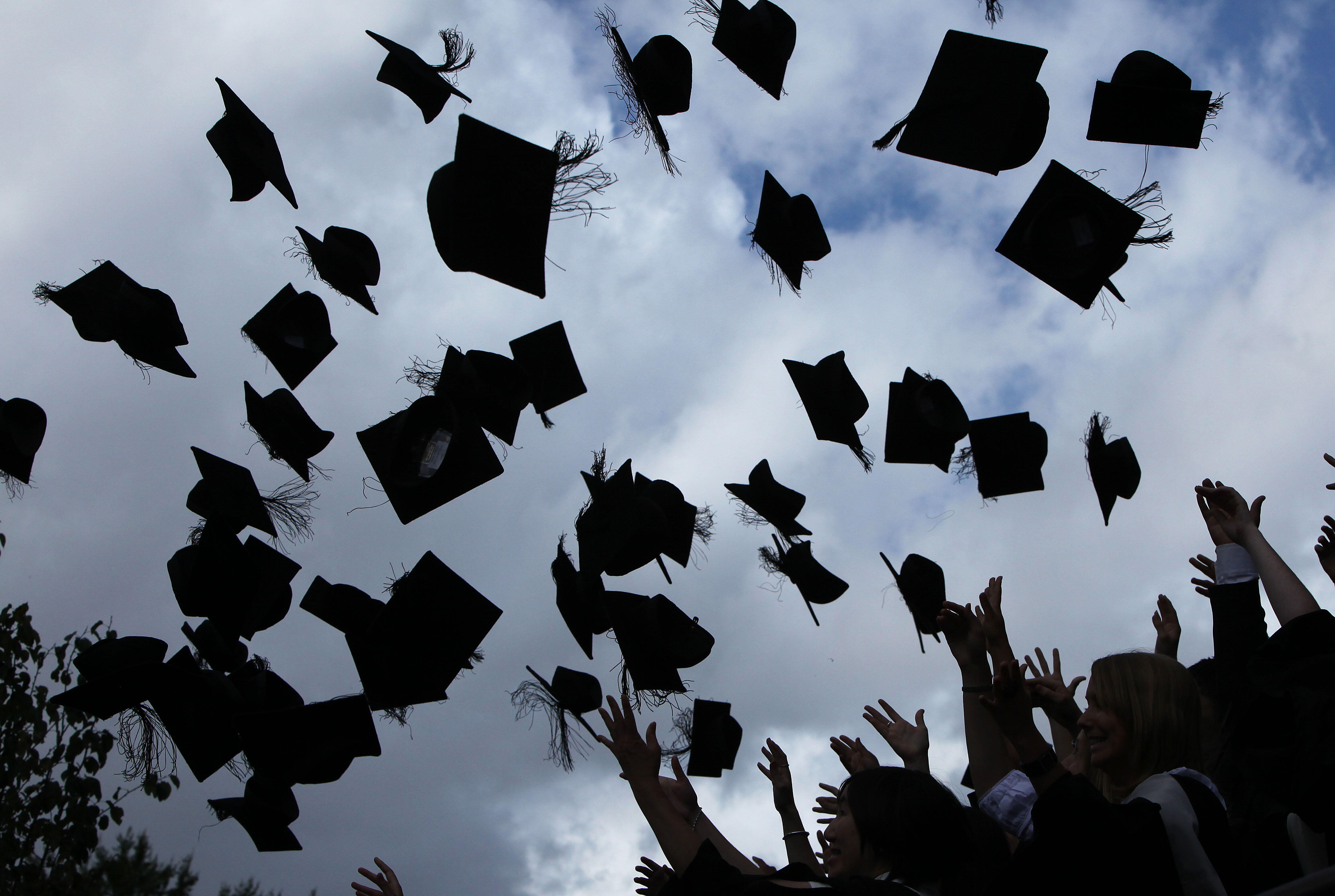 BIRMINGHAM, ENGLAND - JULY 14:  Students throw their mortarboards in the air during their graduation photograph at the University of Birmingham degree congregations  on July 14, 2009 in Birmingham, England. Over 5000 graduates will be donning their robes 