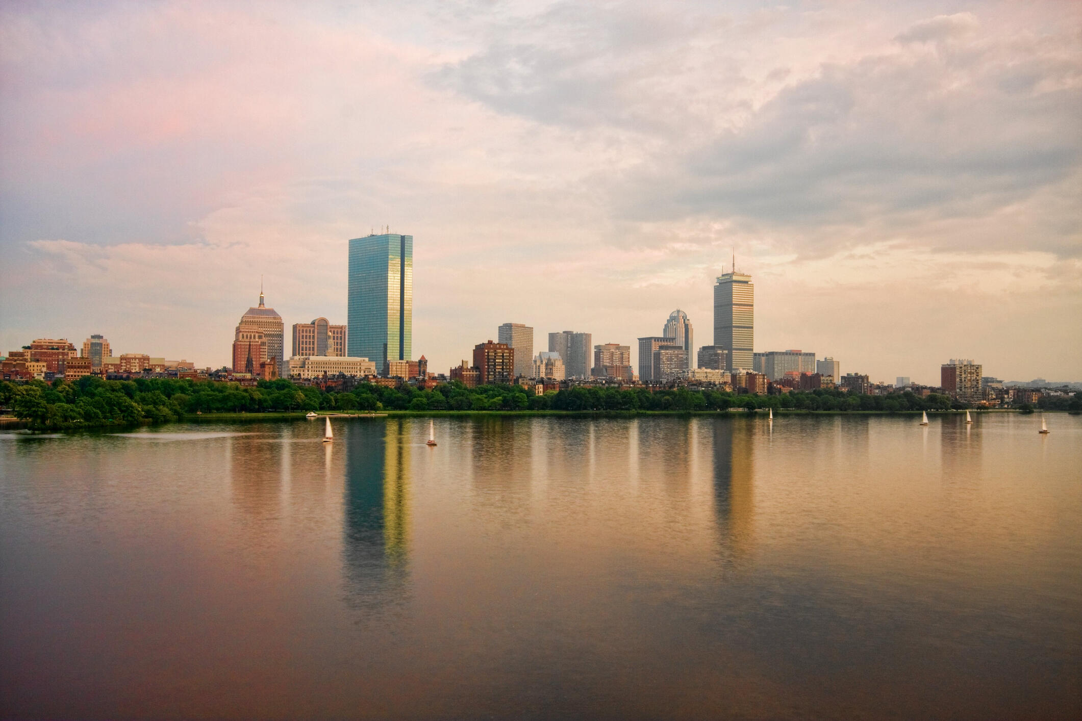 Skyline of Boston Back Bay including John Hancock Tower and Prudential Tower with Charles River in the foreground. Shot during sunset from Longfellow Bridge.