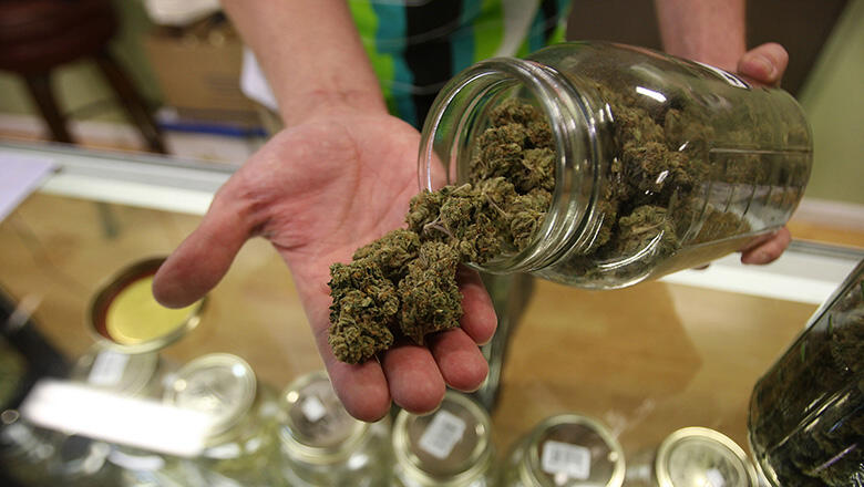 LOS ANGELES, CA - OCTOBER 19:  Dave Warden, a bud tender at Private Organic Therapy (P.O.T.), a non-profit co-operative medical marijuana dispensary, displays various types of marijuana available to patients on October 19, 2009 in Los Angeles, California.