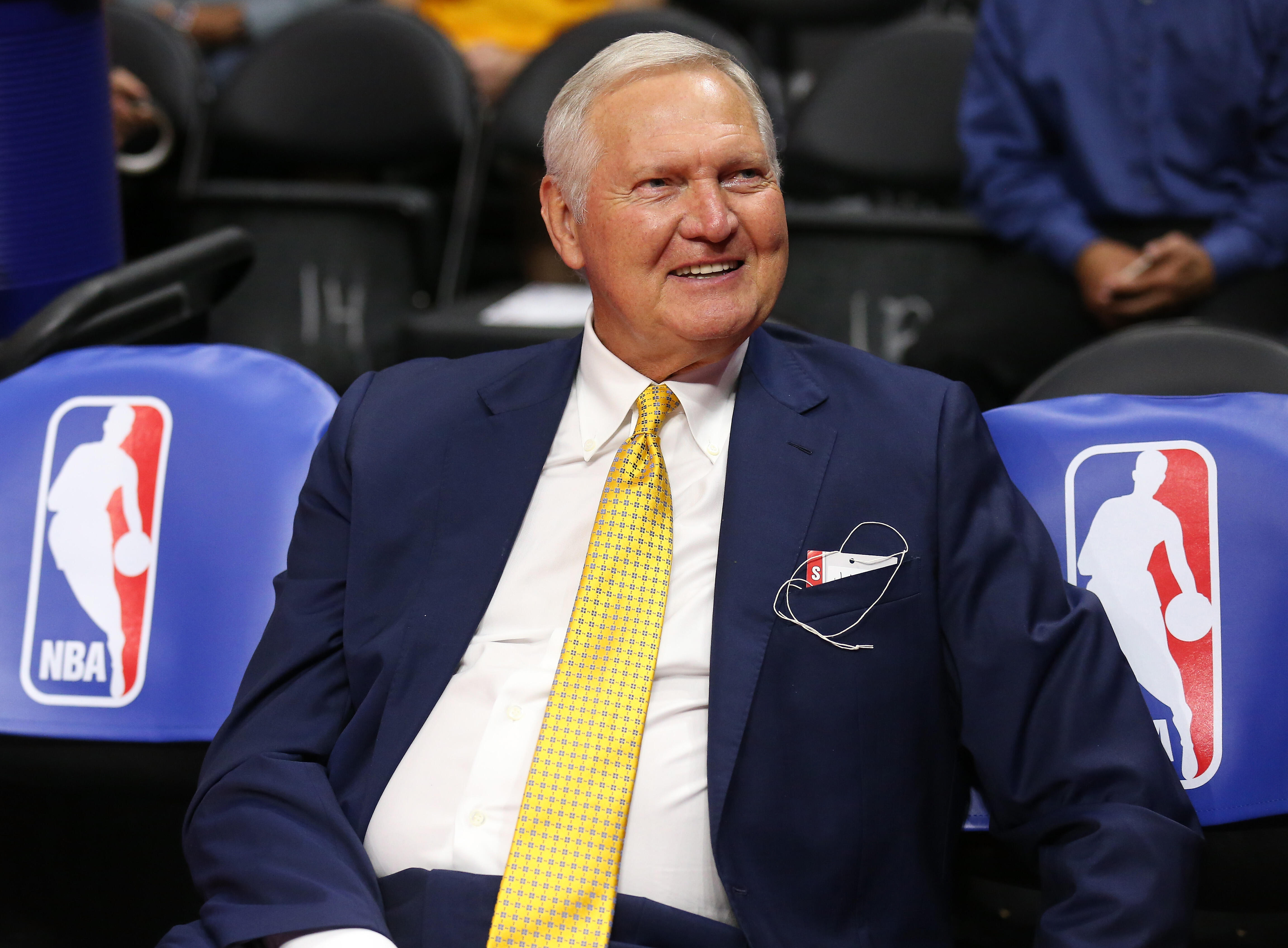 LOS ANGELES, CA - MARCH 31:   Golden State Warriors executive board member Jerry West sits on the bench by NBA logos before the game the Los Angeles Clippers at Staples Center on March 31, 2015 in Los Angeles, California.   NOTE TO USER: User expressly ac