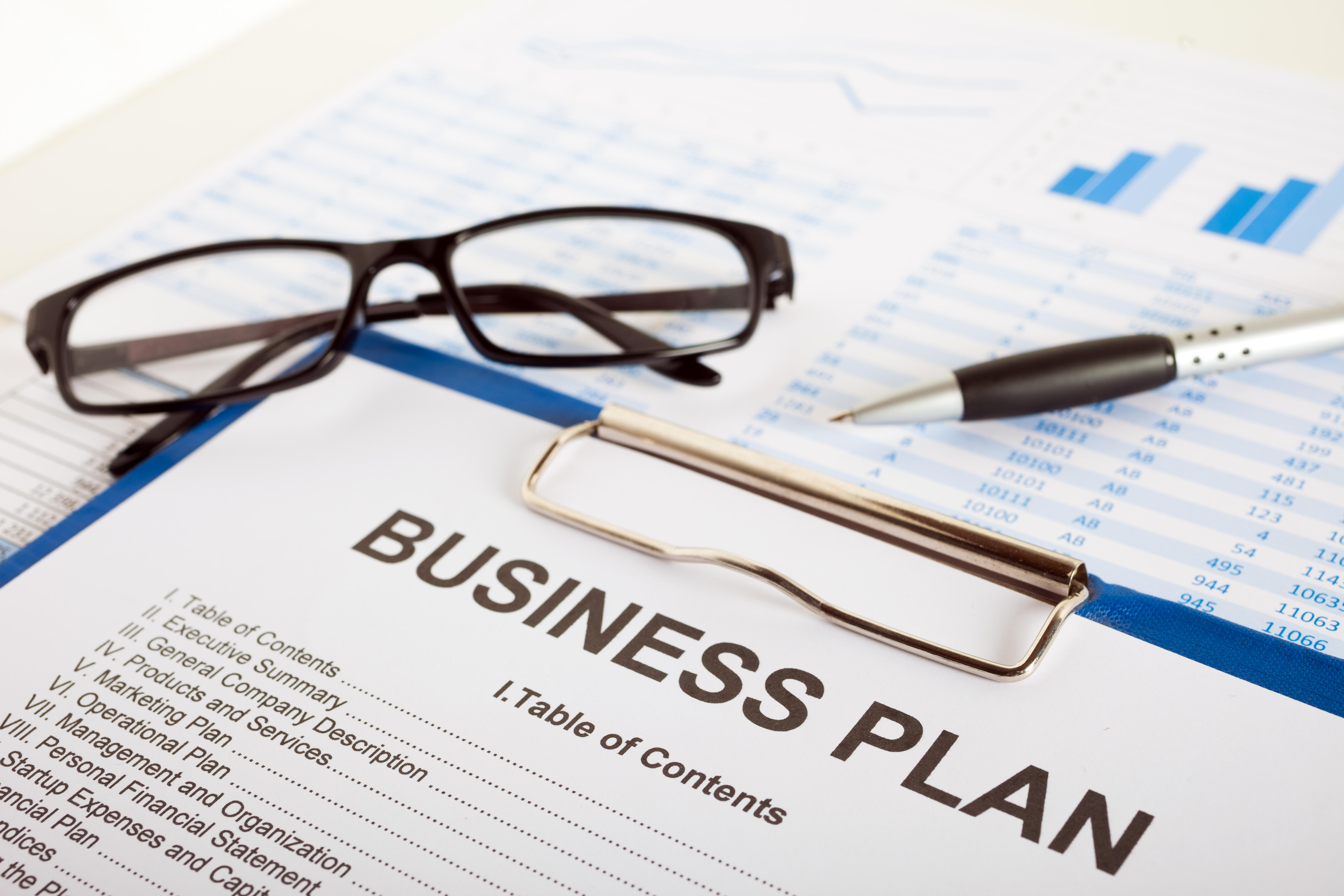 Business plan over financial charts