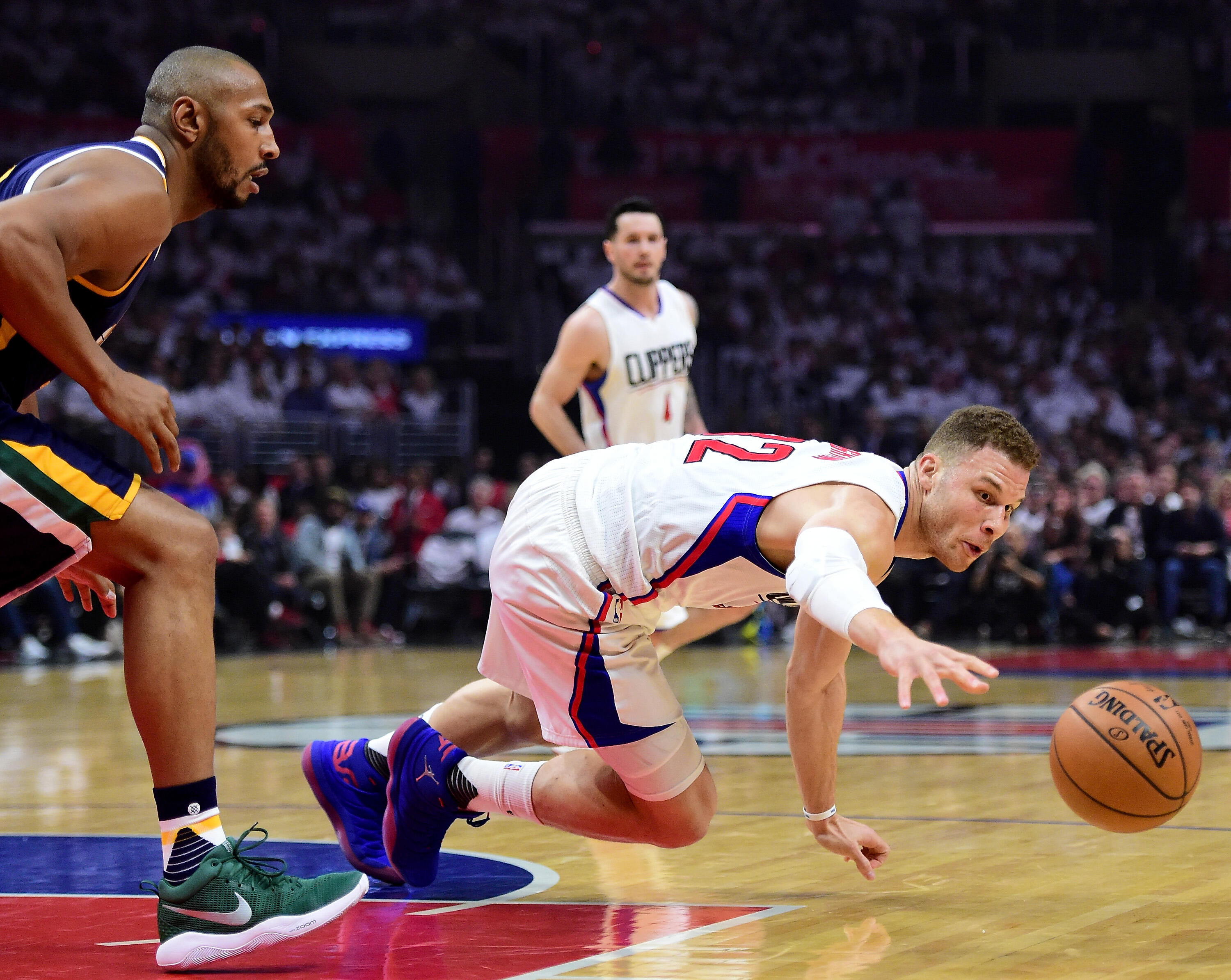 LOS ANGELES, CA - APRIL 15:  Blake Griffin #32 of the LA Clippers dives for a ball in front of Boris Diaw #33 of the Utah Jazz during the first half at Staples Center on April 15, 2017 in Los Angeles, California.  NOTE TO USER: User expressly acknowledges