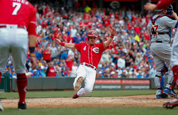 CINCINNATI, OH - APRIL 23: Scooter Gennett #4 of the Cincinnati Reds slides into home after a three run double in the sixth inning against the Chicago Cubs at Great American Ball Park on April 23, 2017 in Cincinnati, Ohio. (Photo by Michael Hickey/Getty Images)