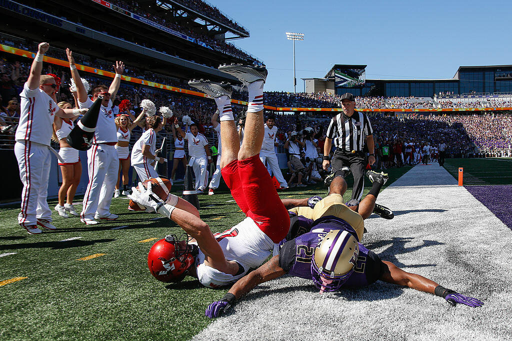 SEATTLE, WA - SEPTEMBER 06:  Wide receiver Cooper Kupp #10 of the Eastern Washington Eagles scores a touchdown against defensive back Kevin King #20 of the Washington Huskies on September 6, 2014 at Husky Stadium in Seattle, Washington.  (Photo by Otto Gr