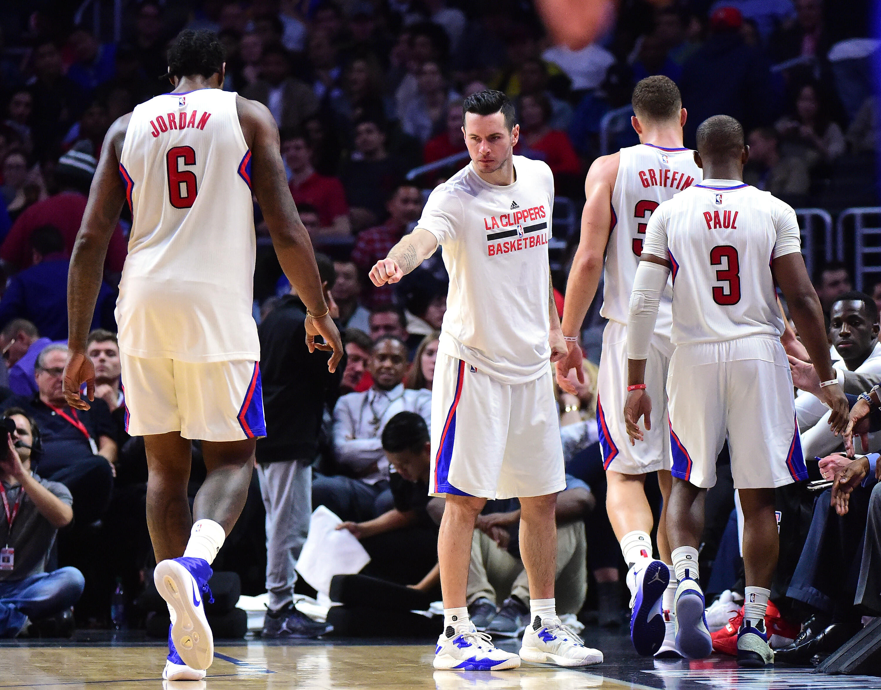 LOS ANGELES, CA - DECEMBER 07:  J.J. Redick #4 of the LA Clippers greets Blake Griffin #32, Chris Paul #3 and DeAndre Jordan #6 as they leave the game during a 115-98 Golden State Warriors win at Staples Center on December 7, 2016 in Los Angeles, Californ