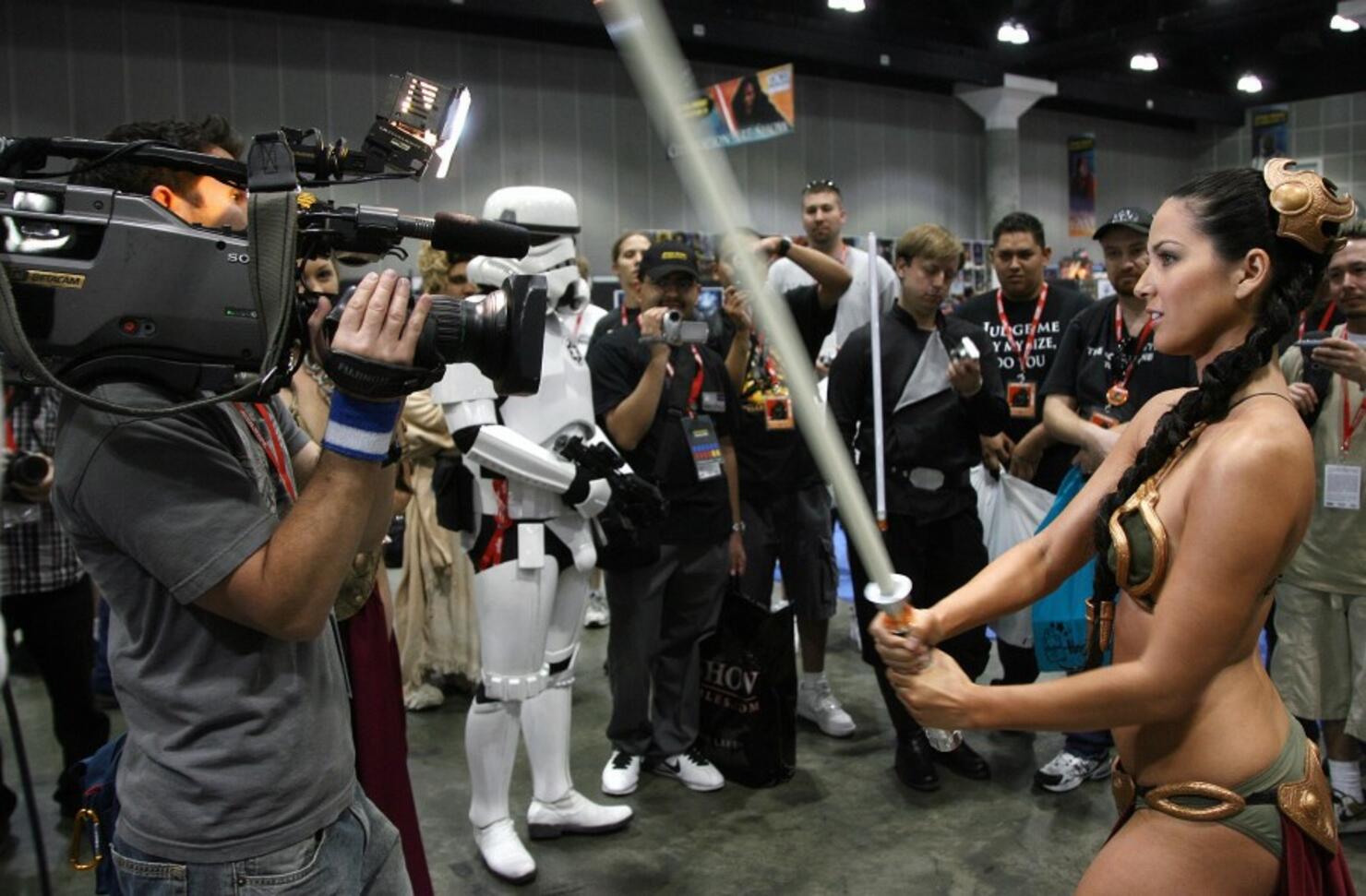 A Star Wars fan performs in font of a TV