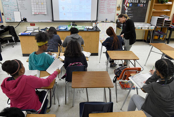 CORRECTION - Science teacher Virginia Escobar-Cheng works with her students in a science class in a high school in Homestead, Florida, on March 10, 2017.  Texas state legislators are now considering a bill introduced in February that would offer teachers like Garlington some legal protection, by giving them latitude to present science 