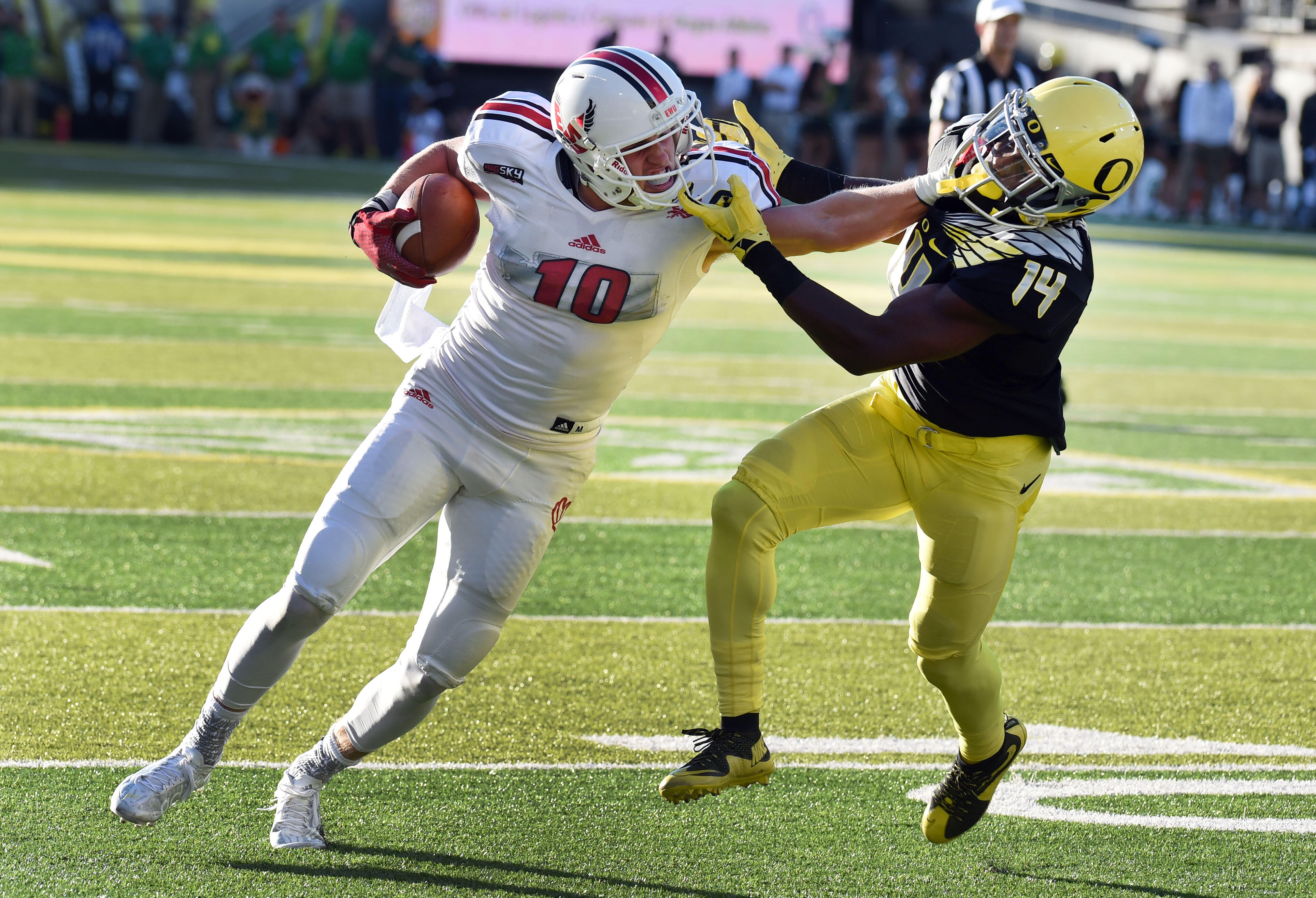 EUGENE, OR - SEPTEMBER 05: Wide receiver Cooper Kupp #10 of the Eastern Washington Eagles stiff arms cornerback Ugo Amadi #14 of the Oregon Ducks on the way to  touchdown during the second quarter of the game against the Oregon Ducks at Autzen Stadium on 
