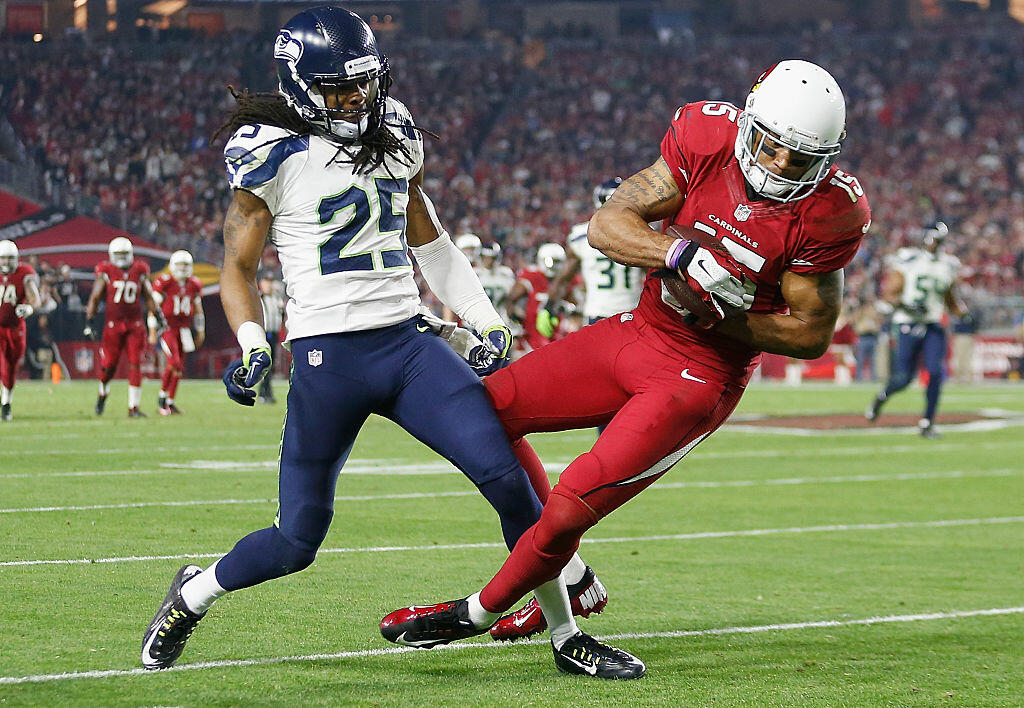 GLENDALE, AZ - DECEMBER 21:  Wide receiver Michael Floyd #15 of the Arizona Cardinals makes a reception past cornerback Richard Sherman #25 of the Seattle Seahawks in the third quarter during the NFL game at the University of Phoenix Stadium on December 21, 2014 in Glendale, Arizona.  (Photo by Christian Petersen/Getty Images)