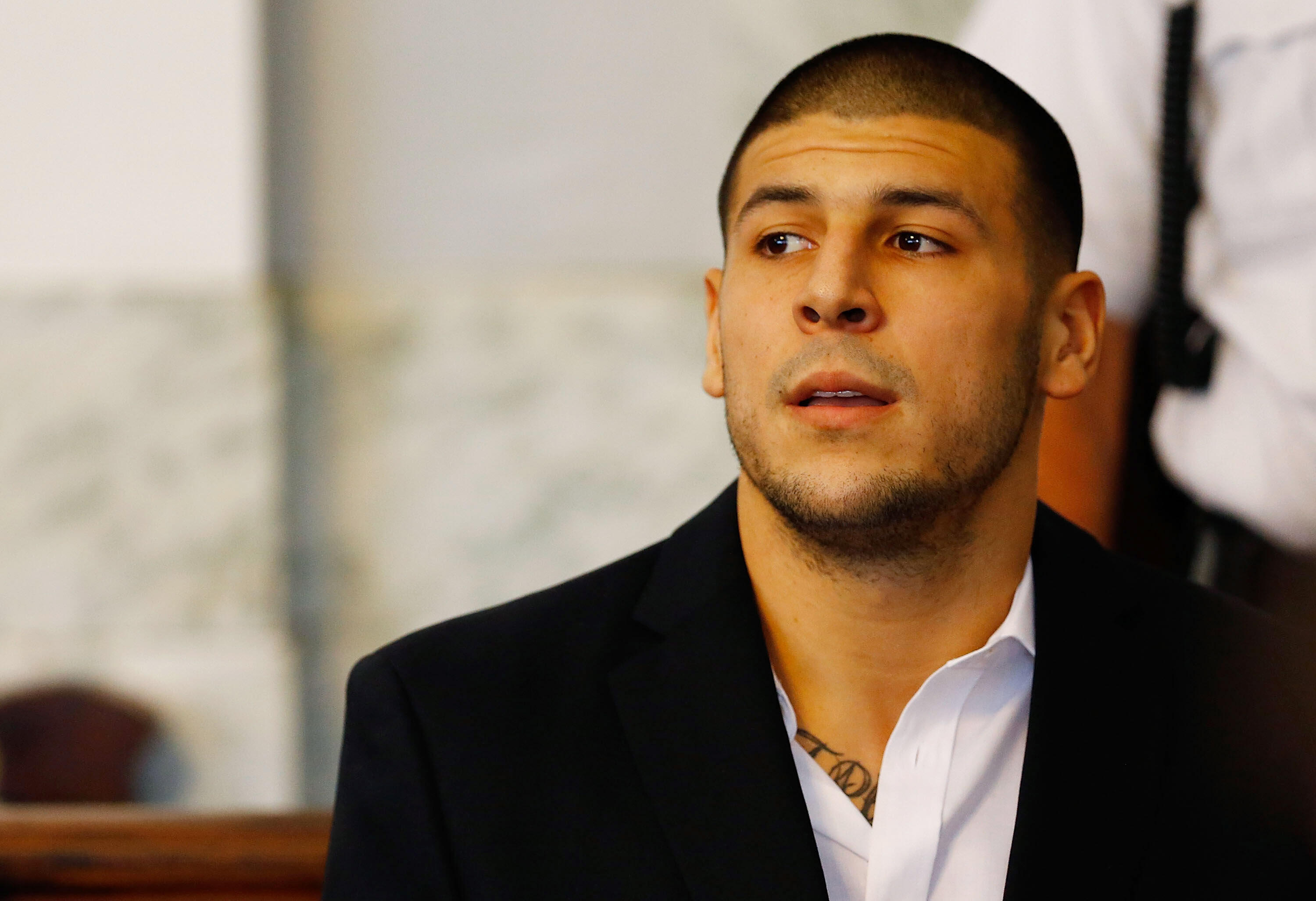 NORTH ATTLEBORO, MA - AUGUST 22: Aaron Hernandez sits in the courtroom of the Attleboro District Court during his hearing on August 22, 2013 in North Attleboro, Massachusetts. Former New England Patriot Aaron Hernandez has been indicted on a first-degree 