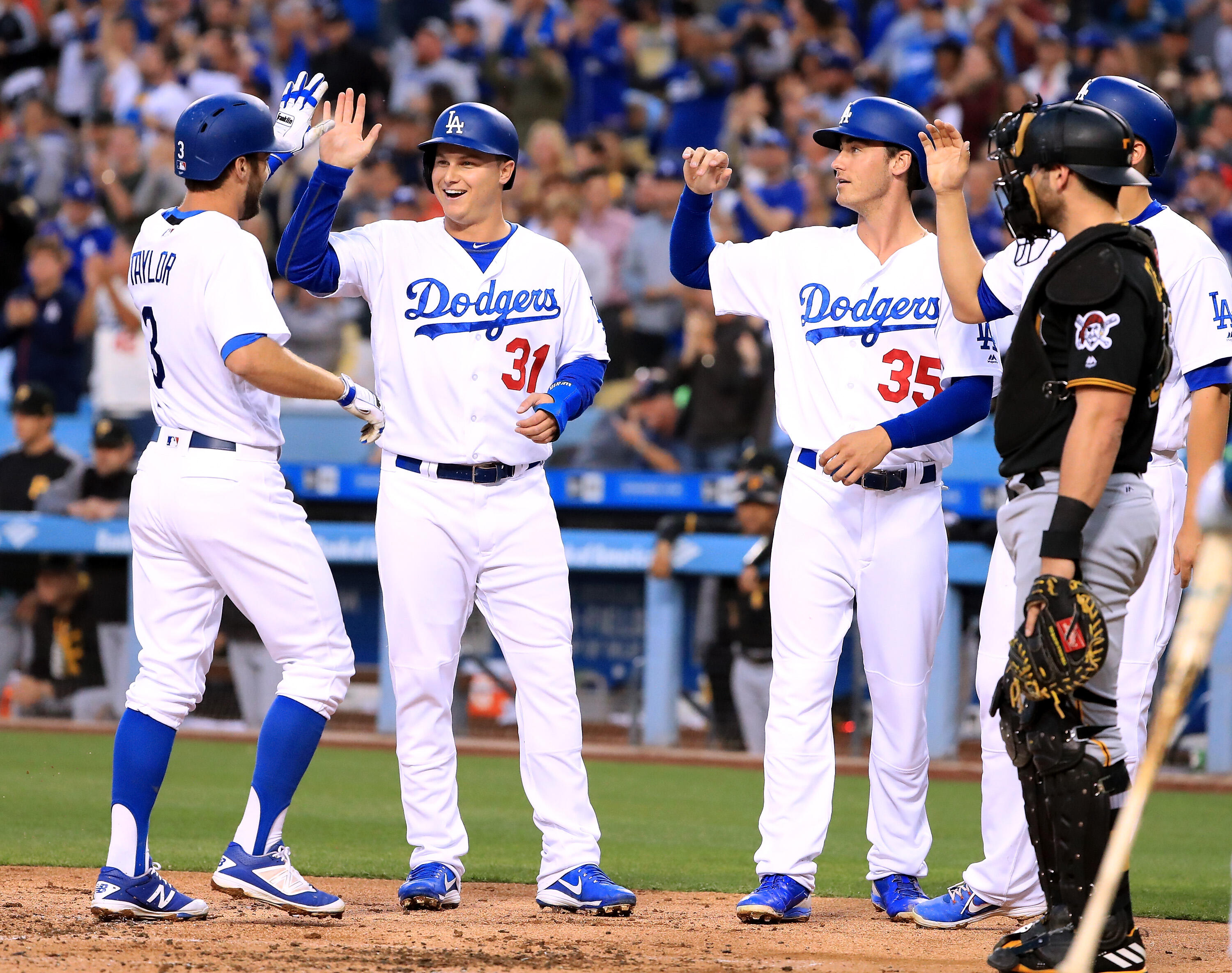 LOS ANGELES, CA - MAY 08:  Chris Taylor #3 of the Los Angeles Dodgers celebrates his grand slam homerun to take a 5-0 lead with Joc Pederson #31, Cody Bellinger #35 and Corey Seager #5 as Francisco Cervelli #29 of the Pittsburgh Pirates looks on during th