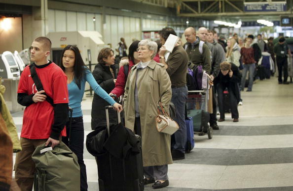 CHICAGO - DECEMBER 22:  Travelers wait in line to check in at O'Hare International Airport December 22, 2006 in Chicago, Illinois. Airlines were forced to play catch-up on this busiest travel day of the holiday season after a snow storm closed the Denver 