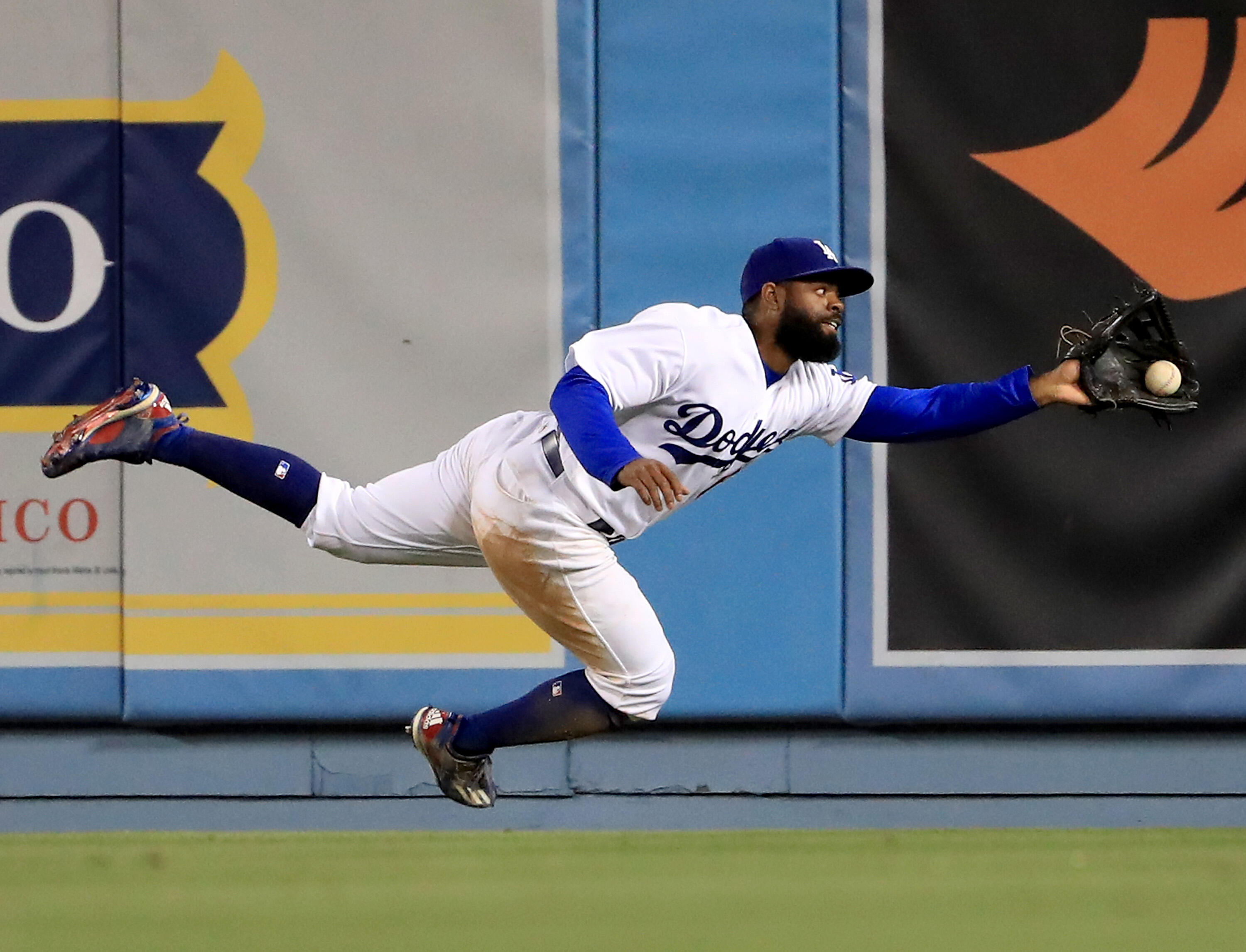 LOS ANGELES, CA - MAY 03:  Andrew Toles #60 of the Los Angeles Dodgers makes a running catch for an out of Hunter Pence #8 of the San Francisco Giants during the 11th inning at Dodger Stadium on May 3, 2017 in Los Angeles, California.  (Photo by Harry How
