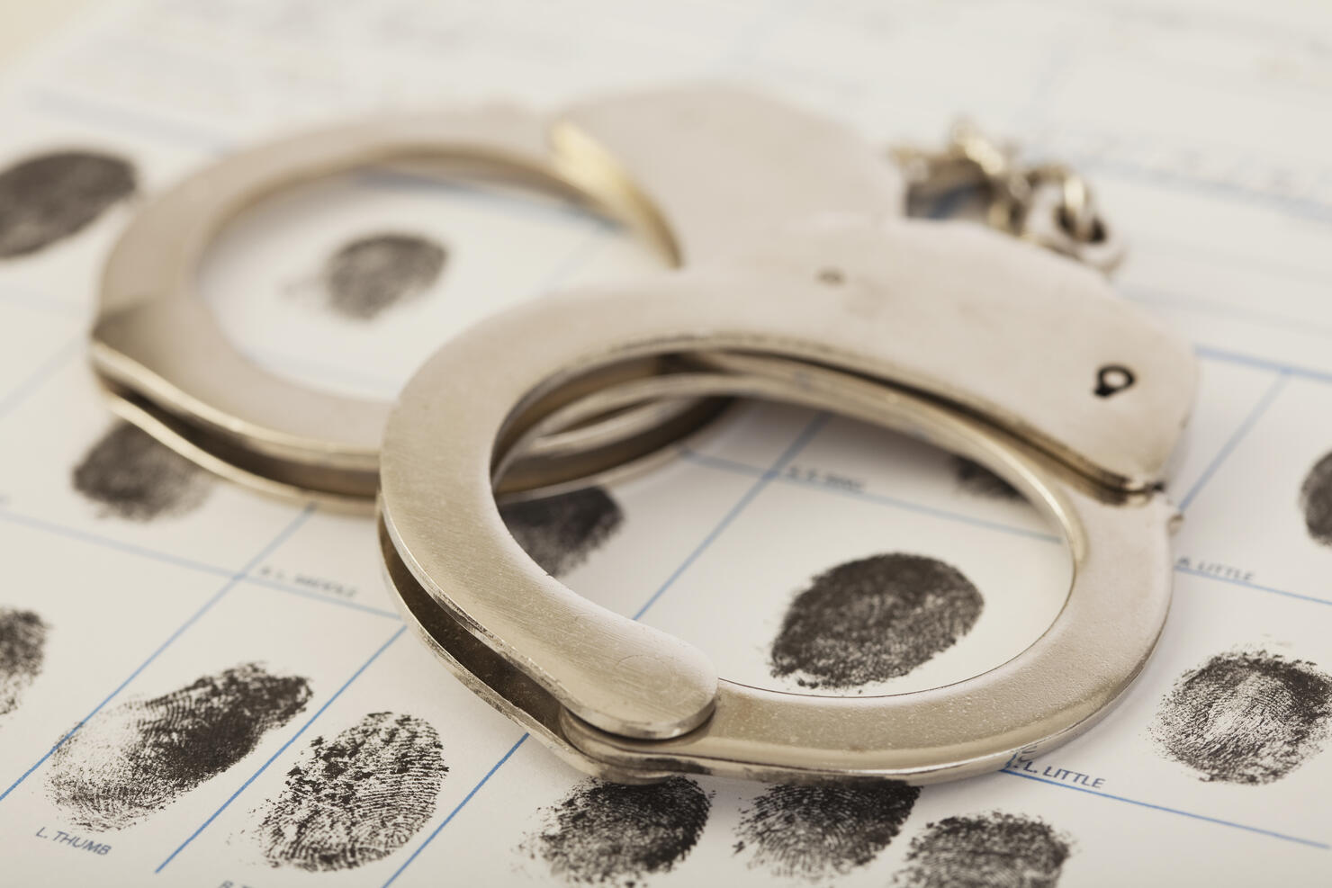 Fingerprint form and handcuffs, high angle view