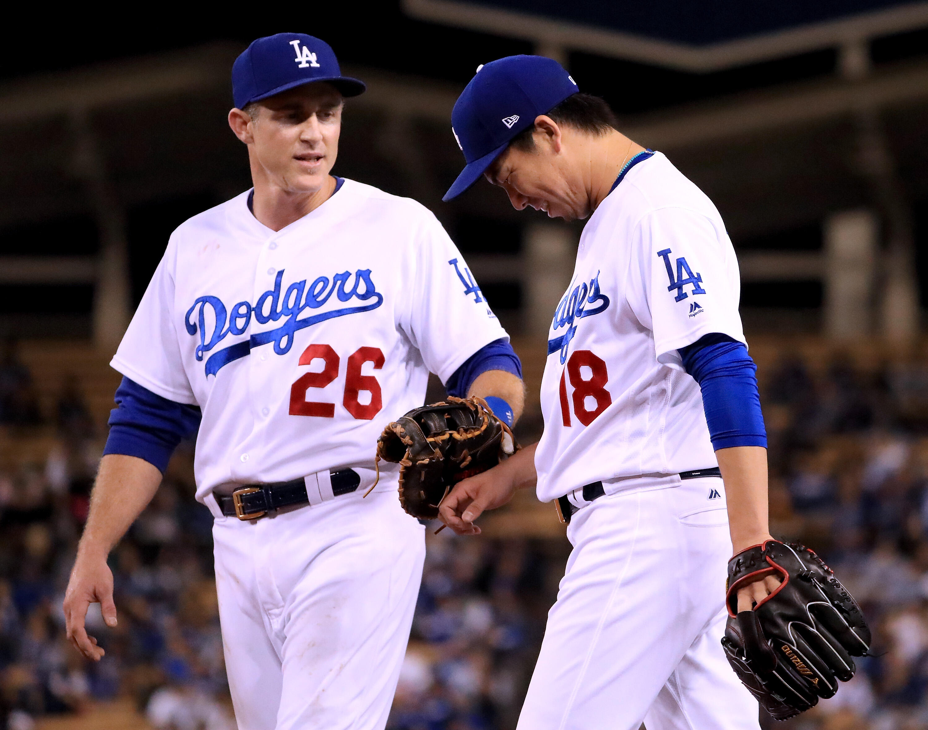 LOS ANGELES, CA - MAY 10:  Kenta Maeda #18 of the Los Angeles Dodgers laughs with Chase Utley #26 after an assist on an out at first during the fifth inning against the Pittsburgh Pirates at Dodger Stadium on May 10, 2017 in Los Angeles, California.  (Pho