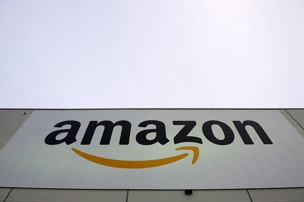 The logo of US online retail giant Amazon is displayed on the Brieselang logistics center, west of Berlin on November 11, 2014. The center is one of nine in Germany. AFP PHOTO / JOHN MACDOUGALL        (Photo credit should read JOHN MACDOUGALL/AFP/Getty Im