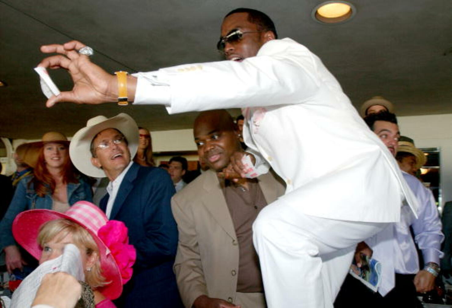 Rapper P Diddy Celebrates A Winning Ticket As Singer George Strait (L) Looks On During T