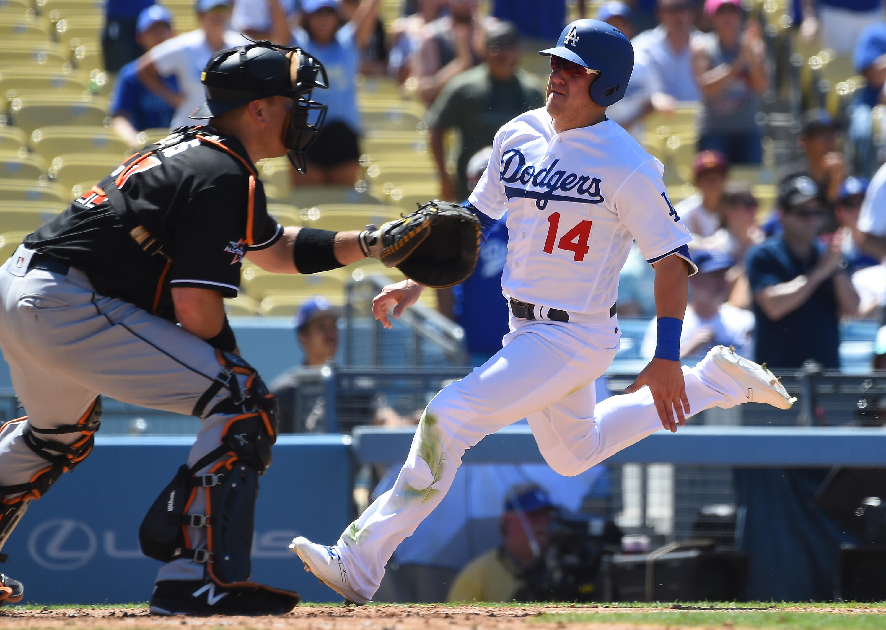 LOS ANGELES, CA - MAY 21:  Enrique Hernandez #14 of the Los Angeles Dodgers beats the throw to A.J. Ellis #17 of the Miami Marlins as he scores on a single by Brett Eibner #50 of the Los Angeles Dodgers in the sixth inning at Dodger Stadium on May 21, 201